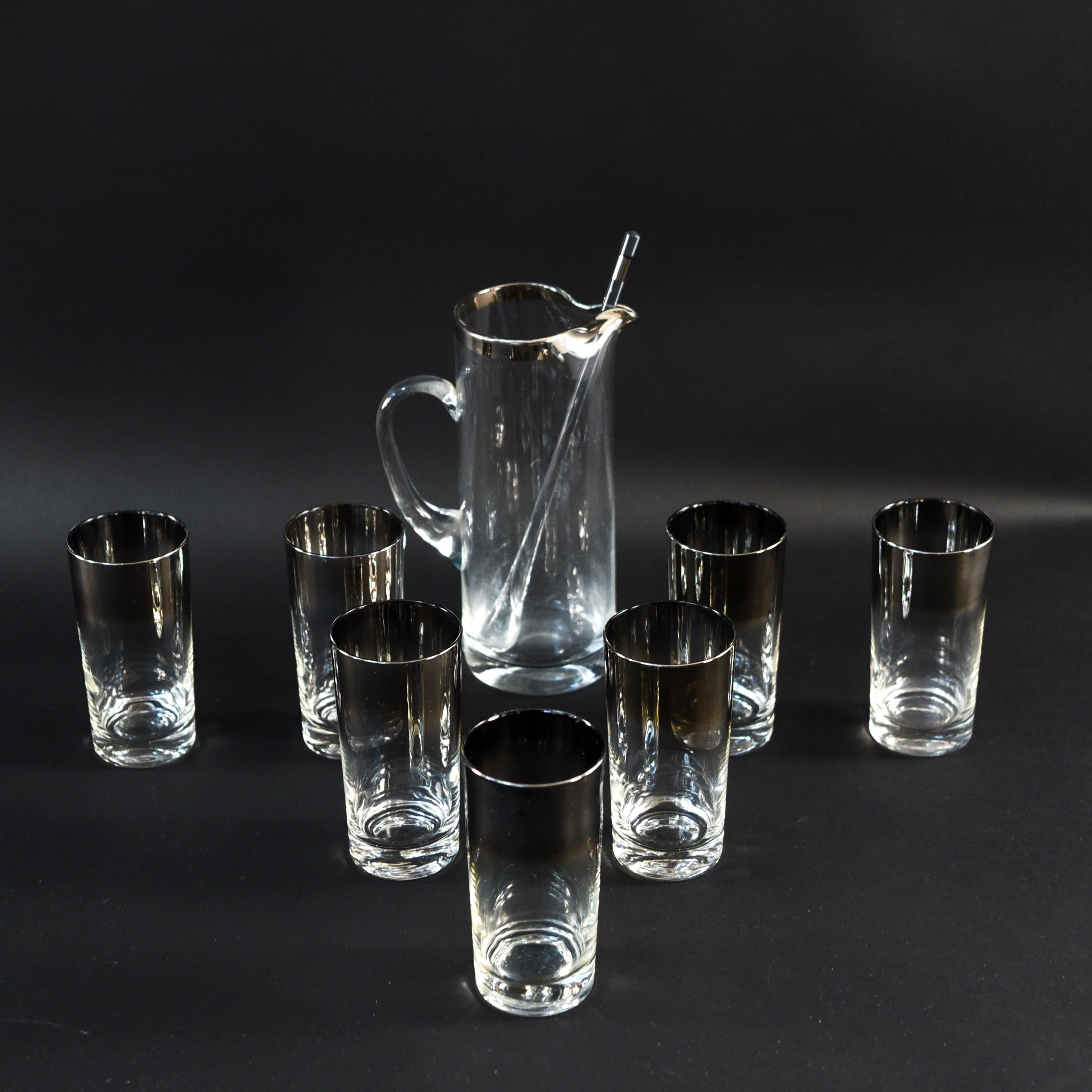 This chrome rimmed pitcher and glass set has a great midcentury look. Includes pitcher, stirrer, and six glasses with a smoky chrome rim.