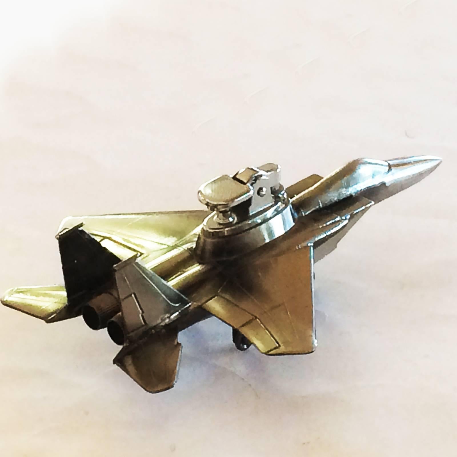 Midcentury cigarette lighter by Manufacturer Hamiltons, USA, who brought out a different Model annually, starting 1930. This is an F-15 Eagle jet, designed by McDonnell Douglas, first flights 1972, Mach 2.5+. Fitted with removable Gas lighter, being