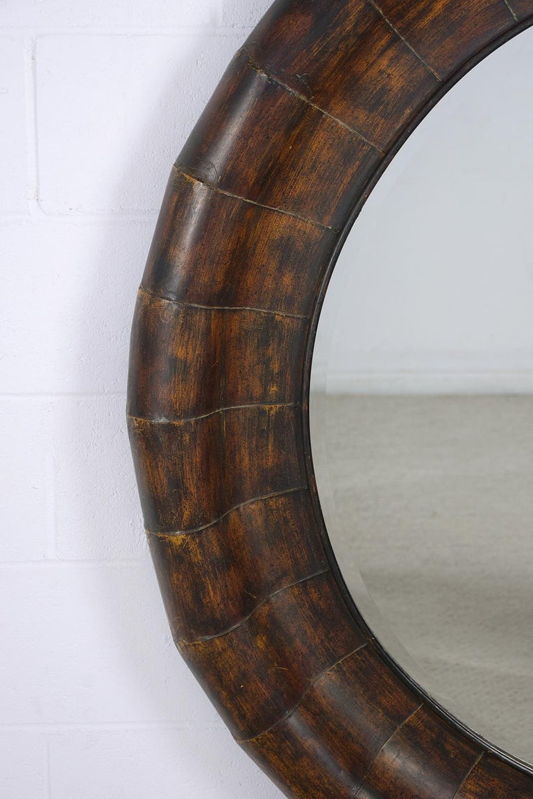 An extraordinary 1970s Mid-Century Modern circular mirror beautiful crafted out of metal and is in great condition. This fabulous large round wall mirror features an eye-catching parchment design frame, a unique brown raw color combination with