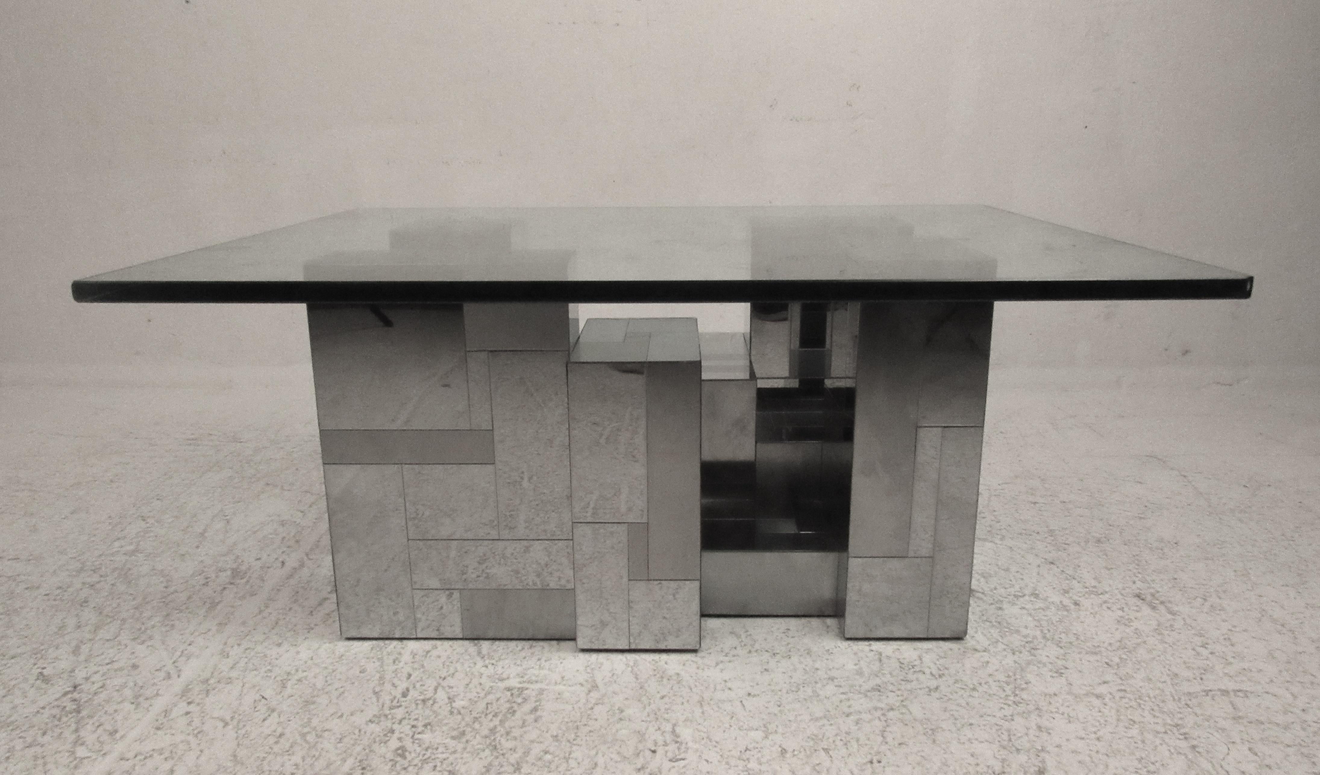 A stunning vintage modern coffee table by Paul Evans for Directional. This sleek table features a chrome patchwork base with a 3/4 inch thick rectangular glass top. The Brutalist style design is sure to make an impression in any setting. Please