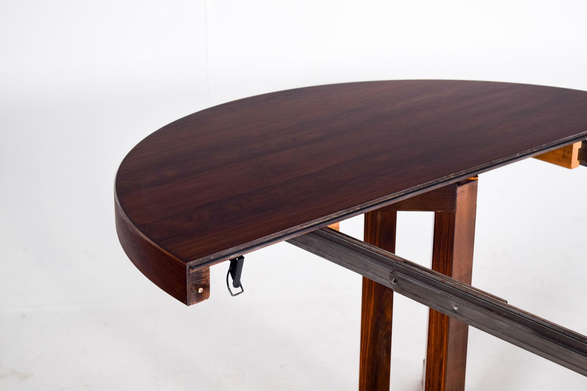 Danish rosewood extending dining table by CJ Rosengaarden, 1960. This large dining table seats 10 to 12 people. Includes four separate extension pieces which can be used individually or together, two with 30 cm each and two with 60 cm each. Total