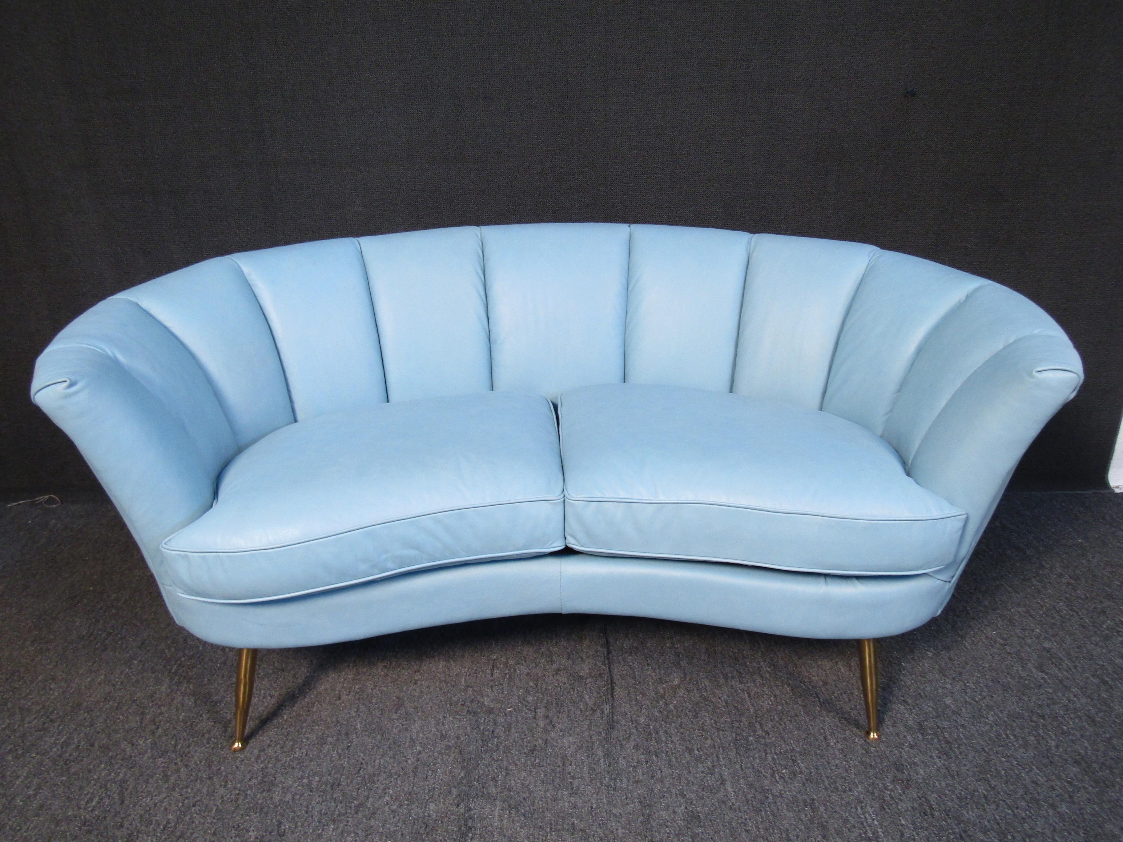 Mid-century clam shell loveseat with bronze-finished legs sure to pop in any living space. (Please confirm item location - NY or NJ - with dealer).
 