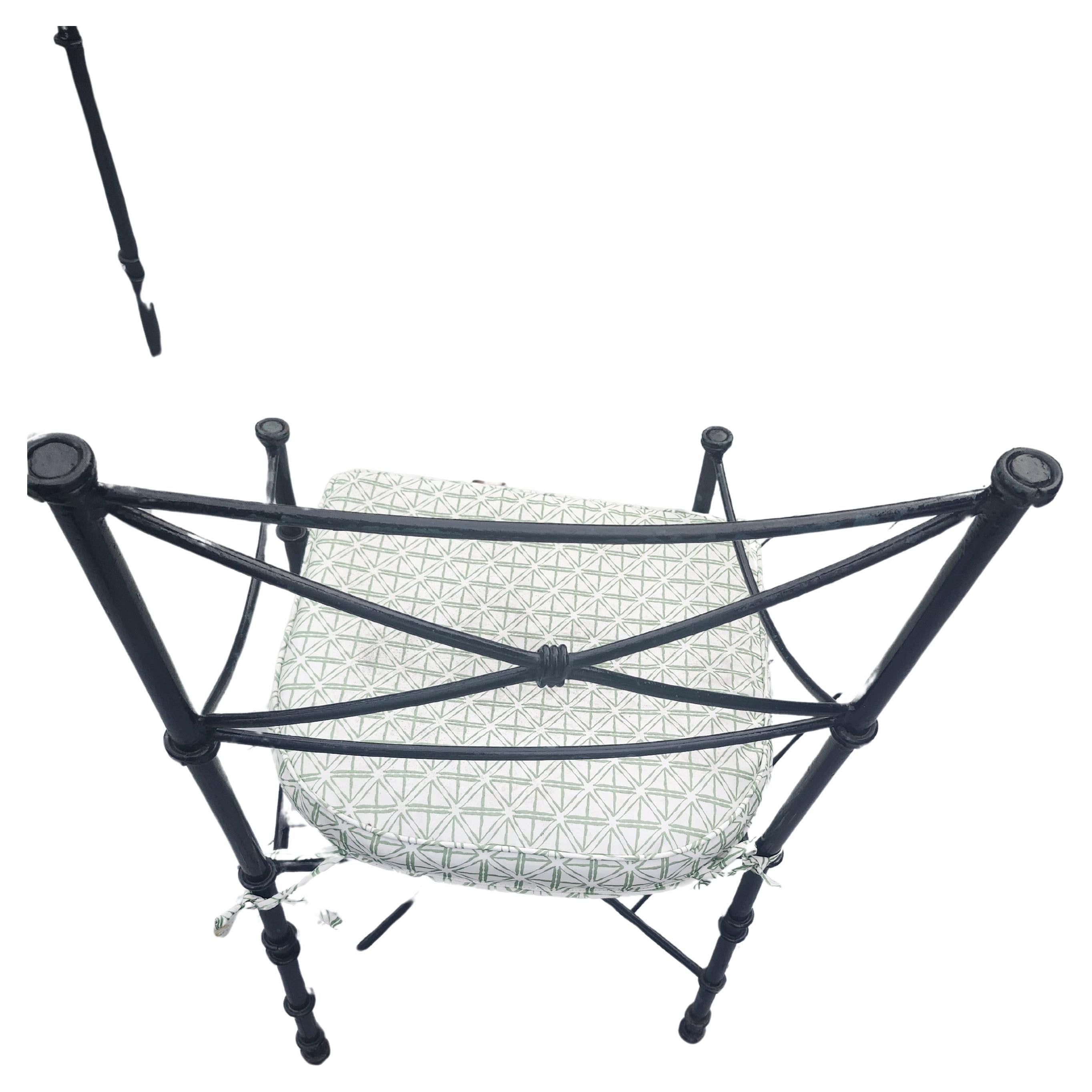 Fantastic simple and elegant design from the John Salterini company borrowing from the Romans using the X stretcher design with ties to the centers of each piece. Also on the chair backs as well. Glass top iron table with 4 high quality iron chairs