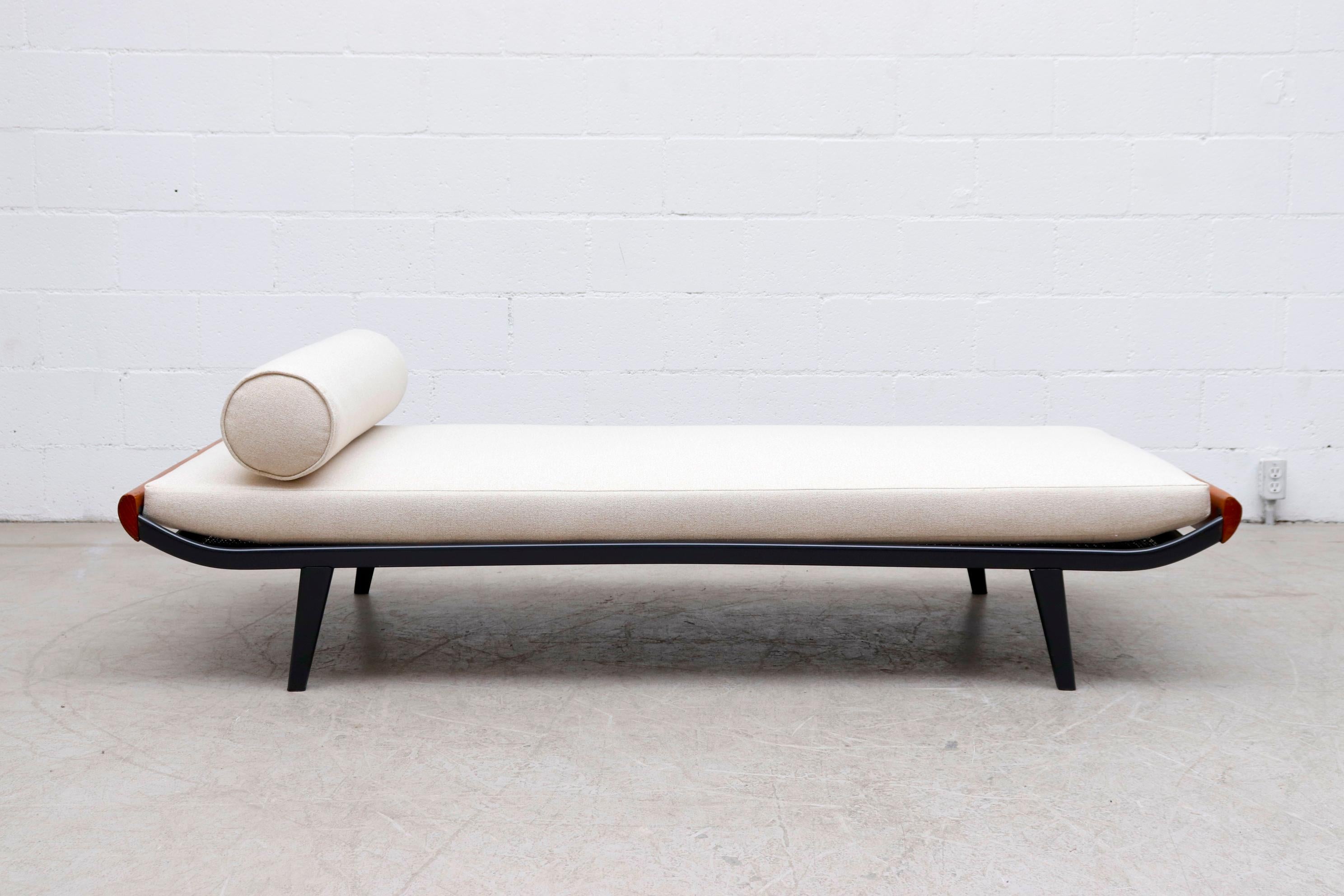 Beautiful 1960s Cleopatra daybed by A.R. Cordemeyer. Lightly refinished teak wood ends with dark grey metal enameled frame and 'Auping' tag on mesh springs with new beige mattress and matching bolster. Frame in original condition with visible