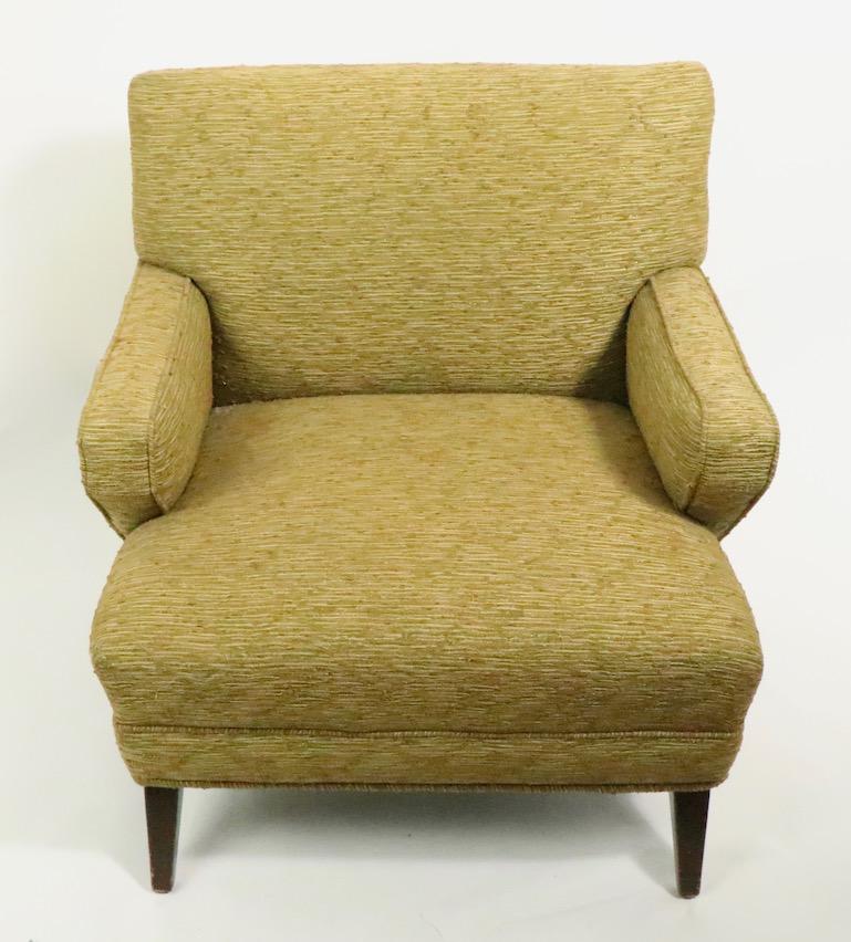 Architectural mid century club chair having stylized angular lines. The chair is structurally sound and sturdy, it will need to be reupholstered as the fabric is worn and faded.
Measures: Total H 29.75 x Arm H 21.25 x Seat H 17 inches.
