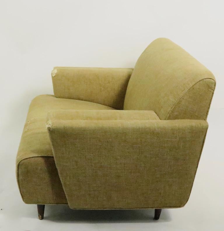 Mid Century club chair having stylish lines and well constructed frame. This example will need to be reupholstered as the fabric is worn and faded.
Measures: Total H 29.5 x arm H 20.5 x seat H 14.5 inches.