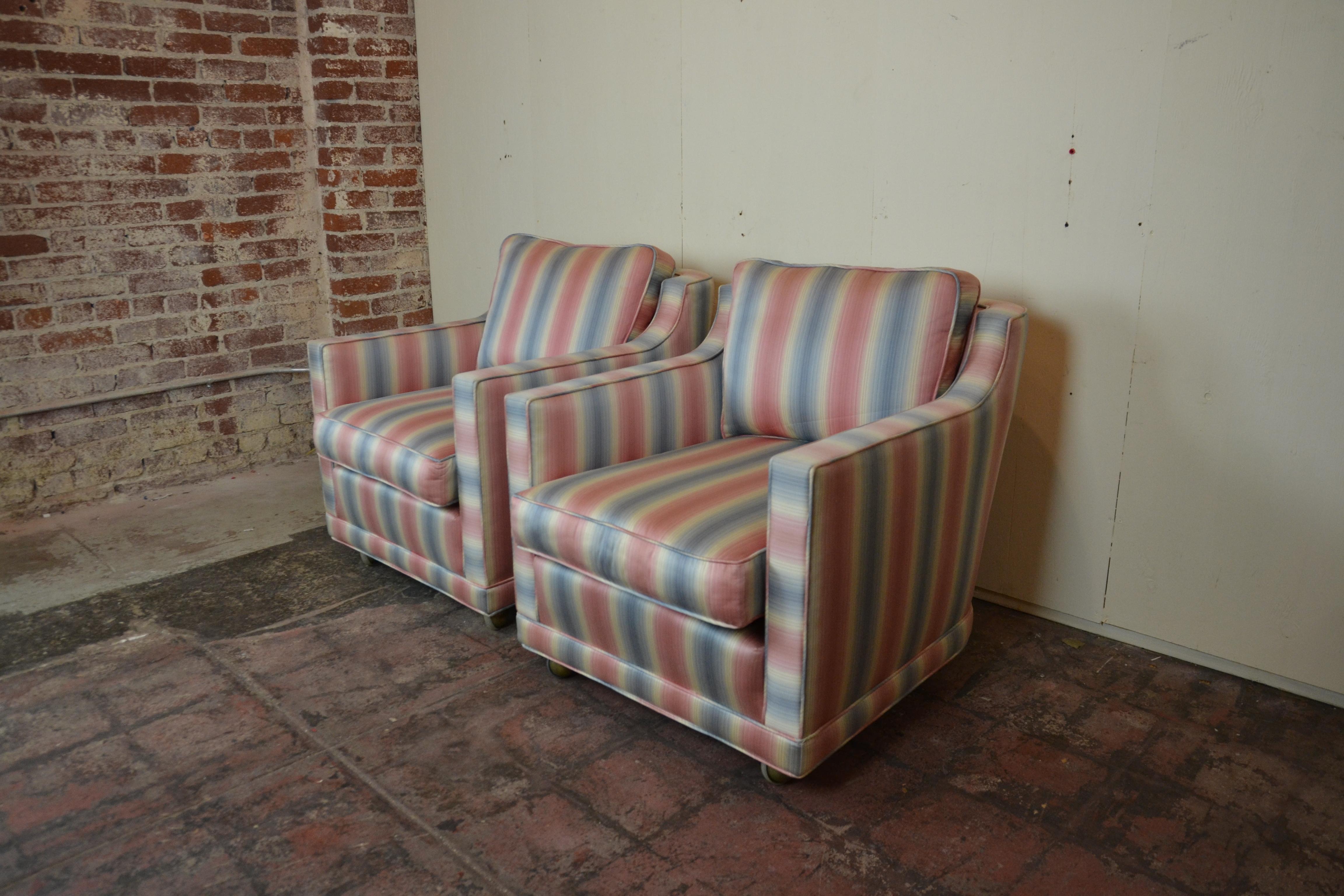 Pair of fine quality midcentury club chairs. Upholstered in striped pink, blue, white fabric. The upholstery is original if the colors work in your decore they do not need reupholstery. The cushions are soft and down fill.