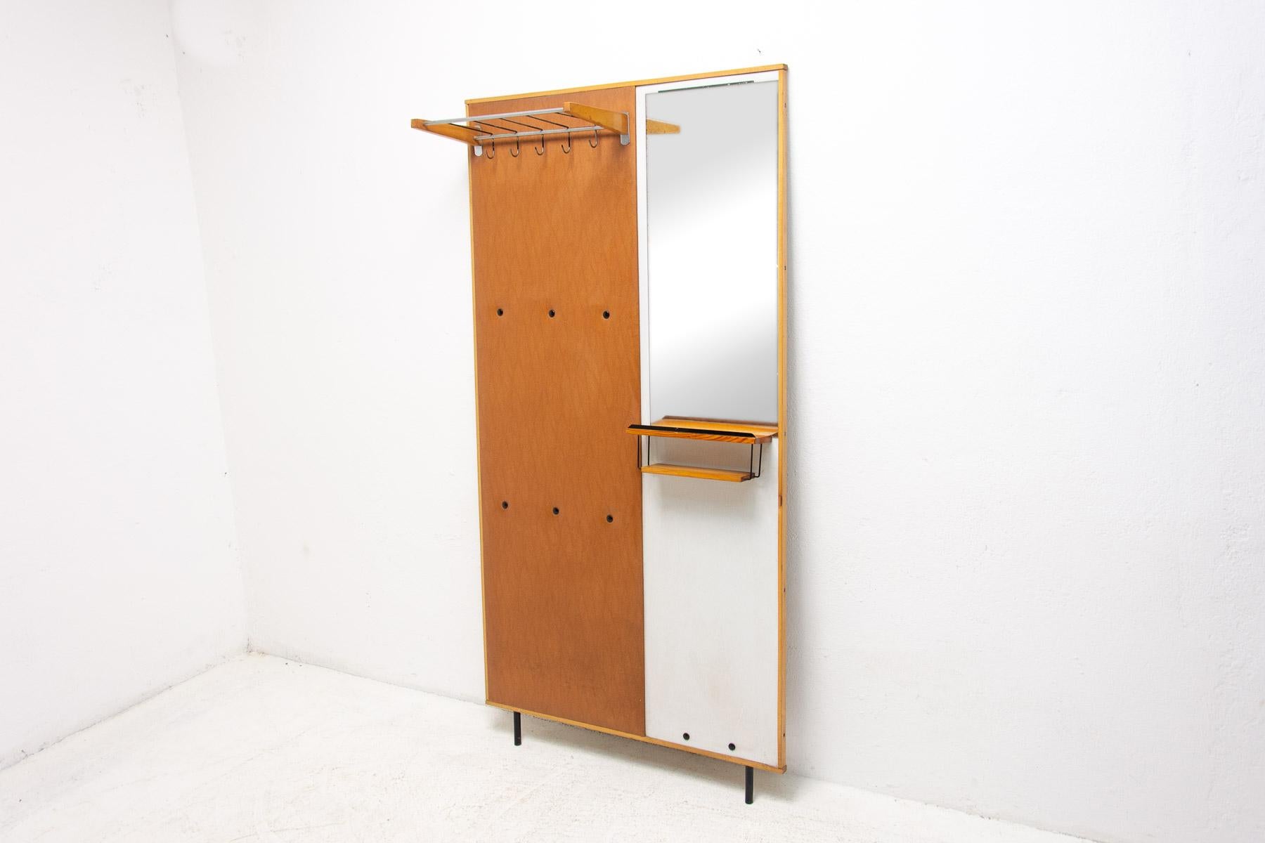 This hall coat rack was made in the former Czechoslovakia in the 1960s and produced by DREVOTVAR. Material: plywood, wood, leatherette, metal. It can be mounted on the wall or laid freely on the floor.

It is a characteristic example of