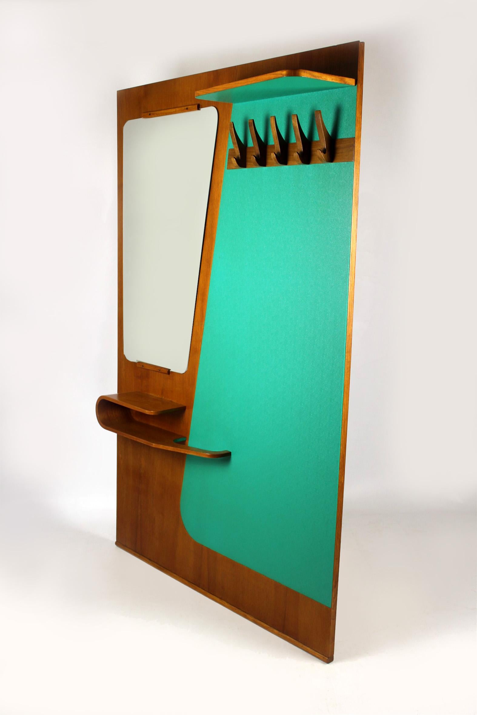 This midcentury coat rack with mirror features wooden hooks and a bent plywood shelf with an umbrella stand.