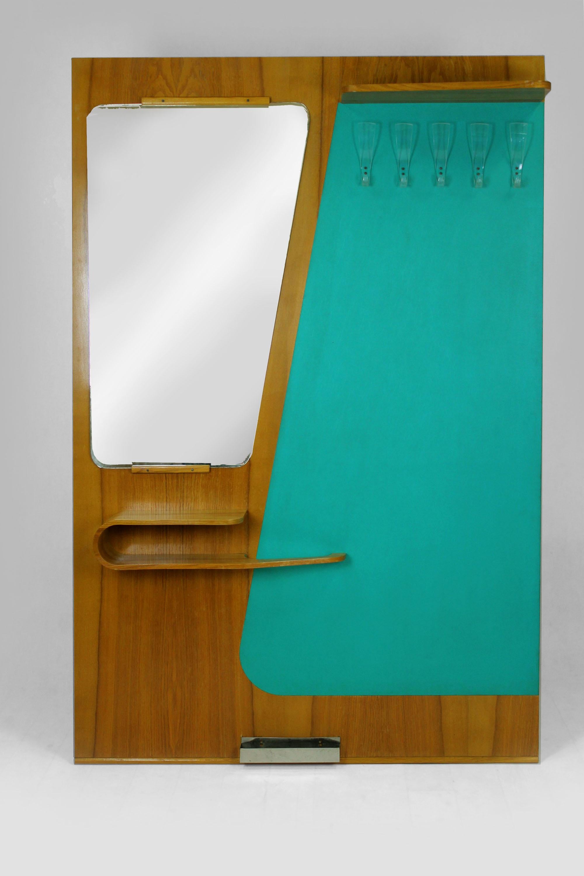 This mid-century coat rack with mirror was produced in 1965 by Kovo-Drevo in Czechoslovakia. It features hooks and a bent plywood shelf with an umbrella stand.
  