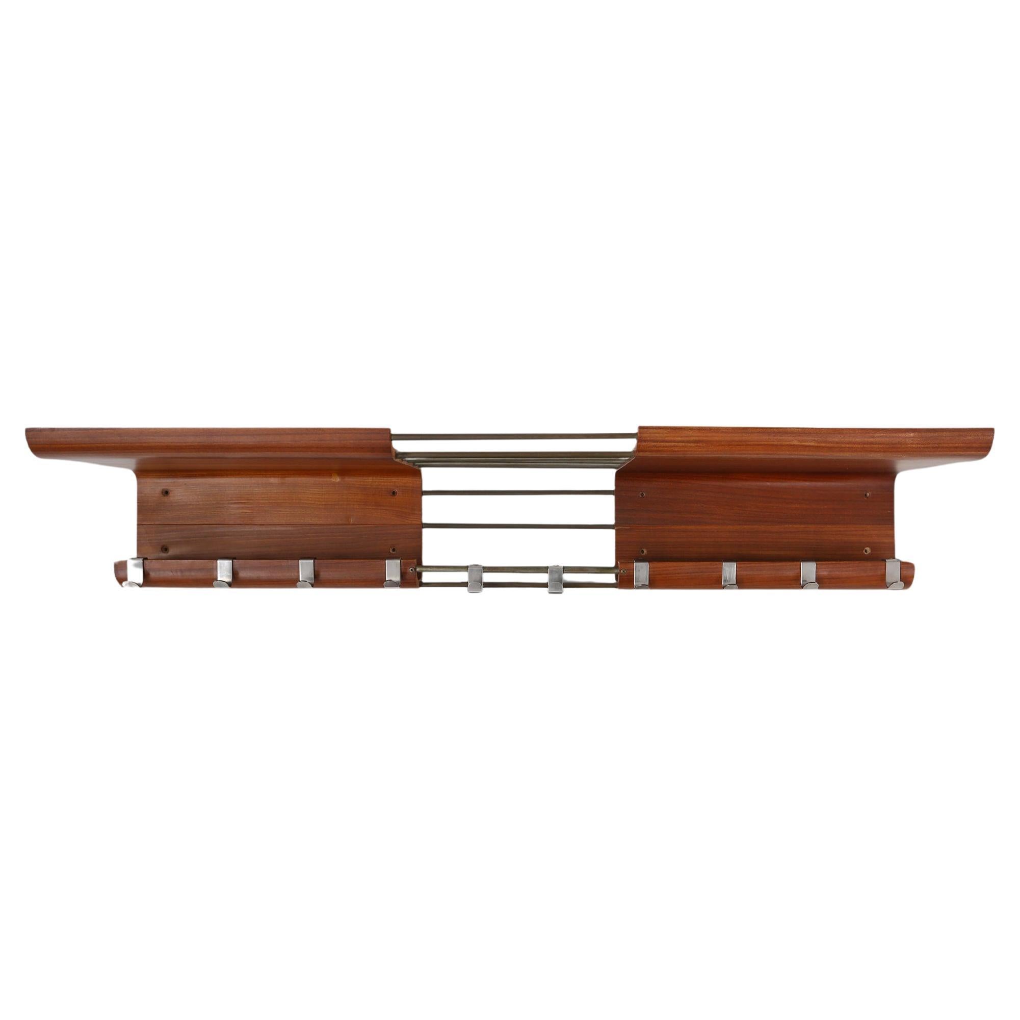 Belgium / 1960 / coatrack / De Coene / wood and metal / mid-century / design / vintage

Sleek designed coatrack by De Coene Freres, Belgium, ca. 1960. This exquisite wooden coat rack in bent plywood with metal hooks and metal bars seamlessly blends