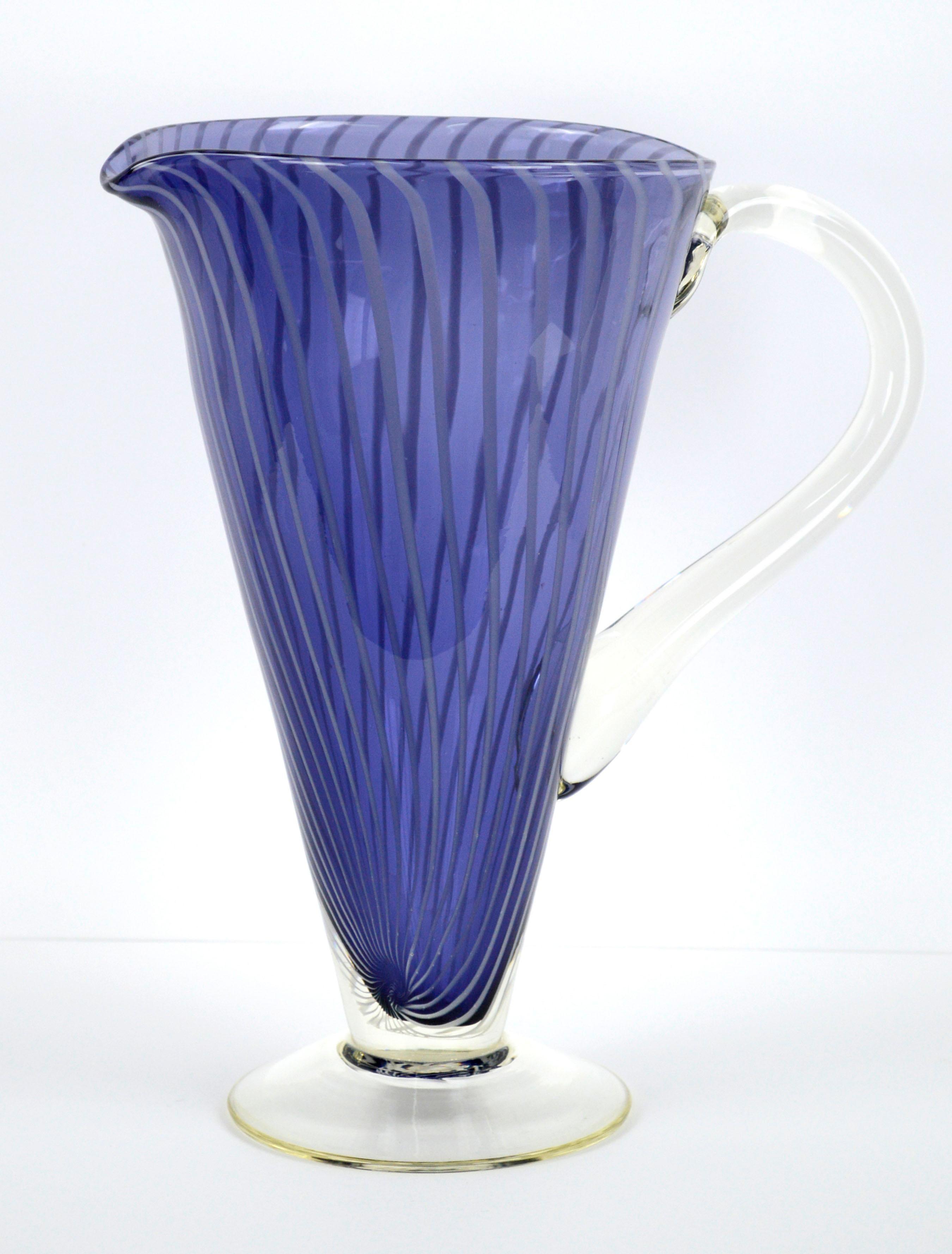 Mid-Century Modern cobalt blue and white striped filigrana Murano glass pitcher. 

Bold cobalt blue with subtle white vertical stripes that twist organically towards the base give this piece a hand crafted touch. Perfect for a contemporary urban,
