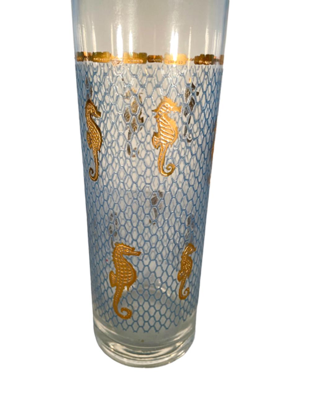 Cylindrical form cocktail pitcher with double, shaped ice dam / pour spouts decorated with raised gold seahorses against a ground of raised translucent blue netting 'suspended' by raised gold fishing net floats.
