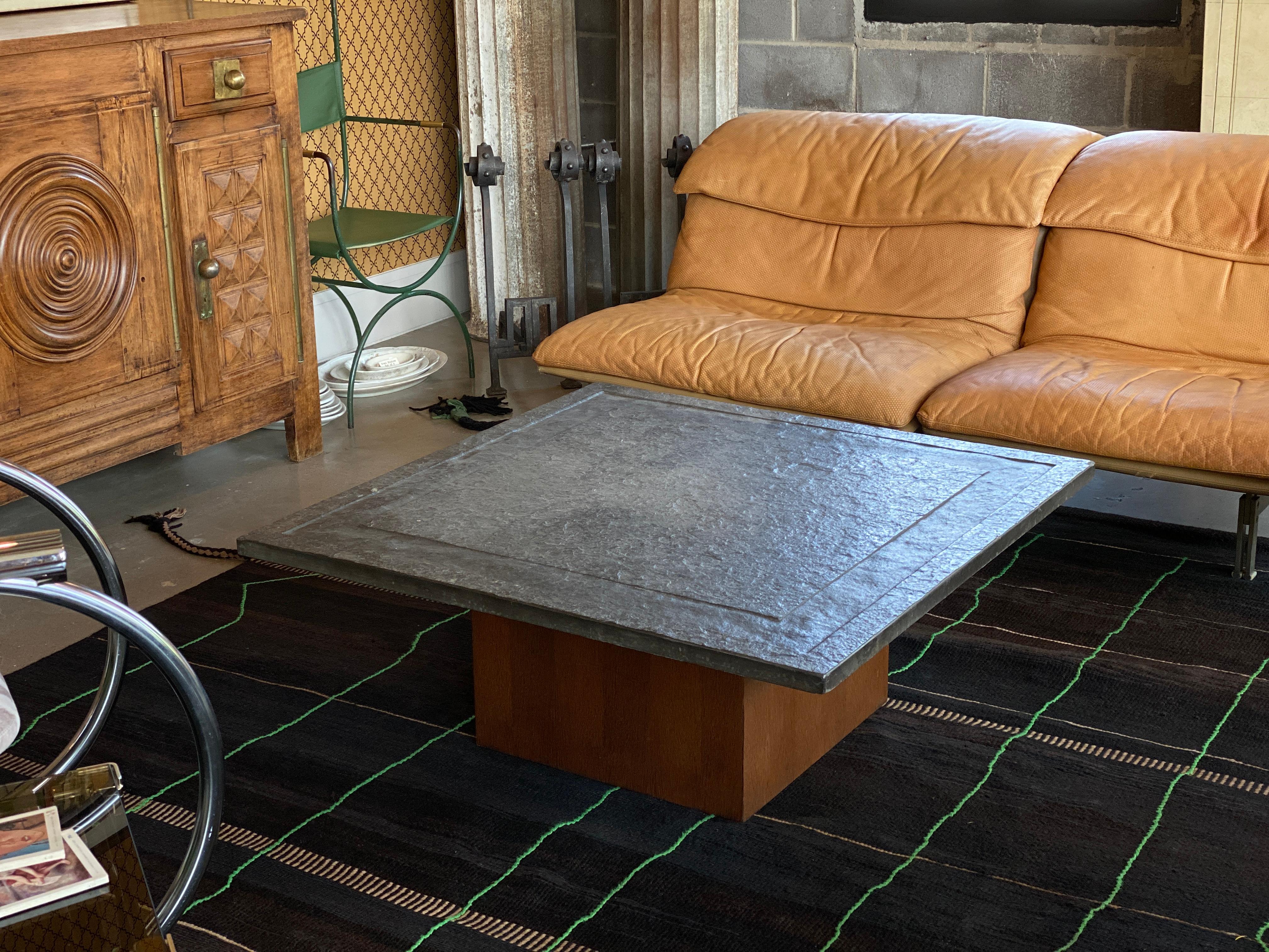 Cocktail table with square wood base and Belgian bluestone top, here with more of a green tint, and a carved ridge. Stone is similar in texture to slate. In the 1960-1970 Brutalist tradition of Belgium.