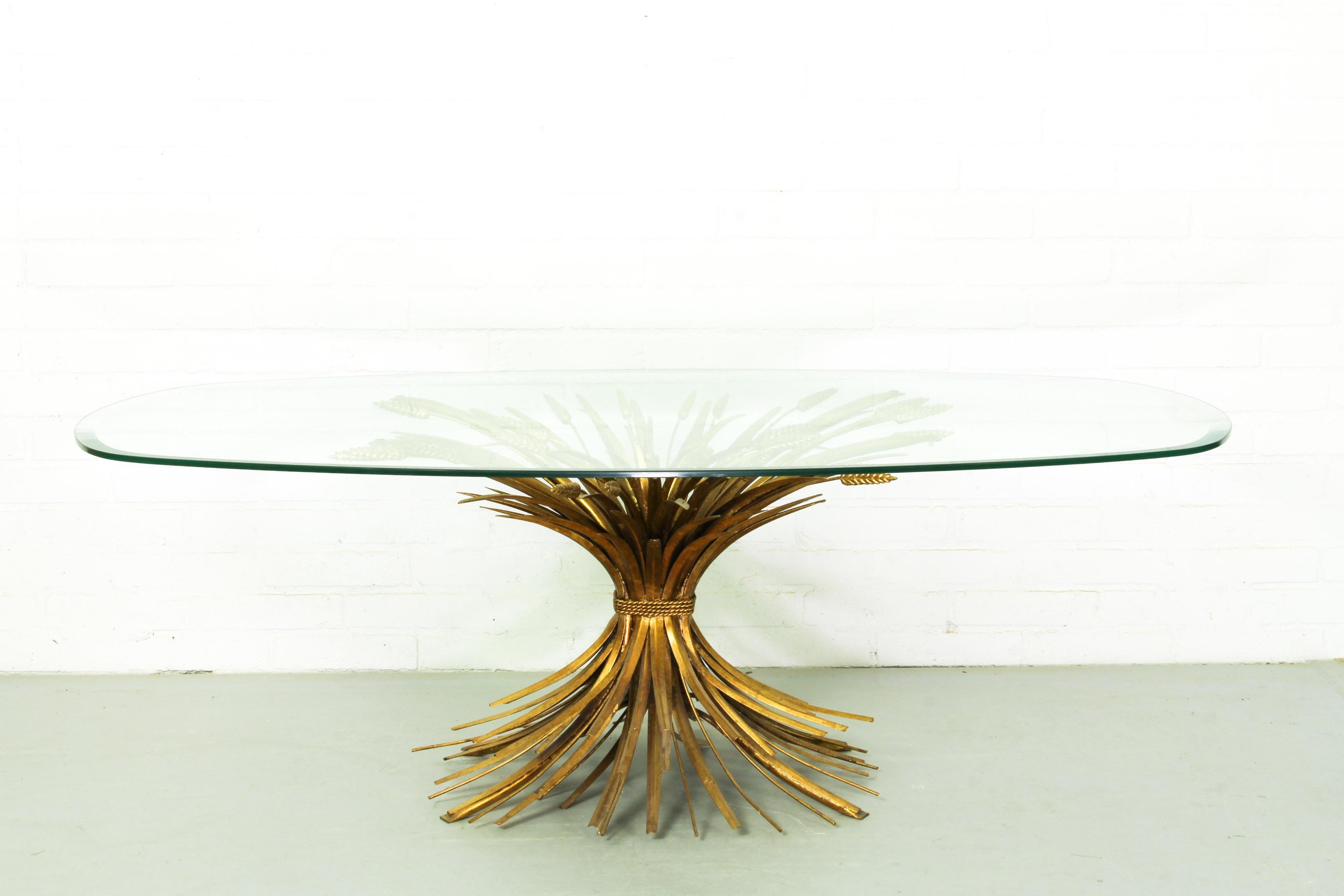 Midcentury gilt gold sheat of wheat table with oval beveled clear glass top. This piece is in excellent condition.  
  