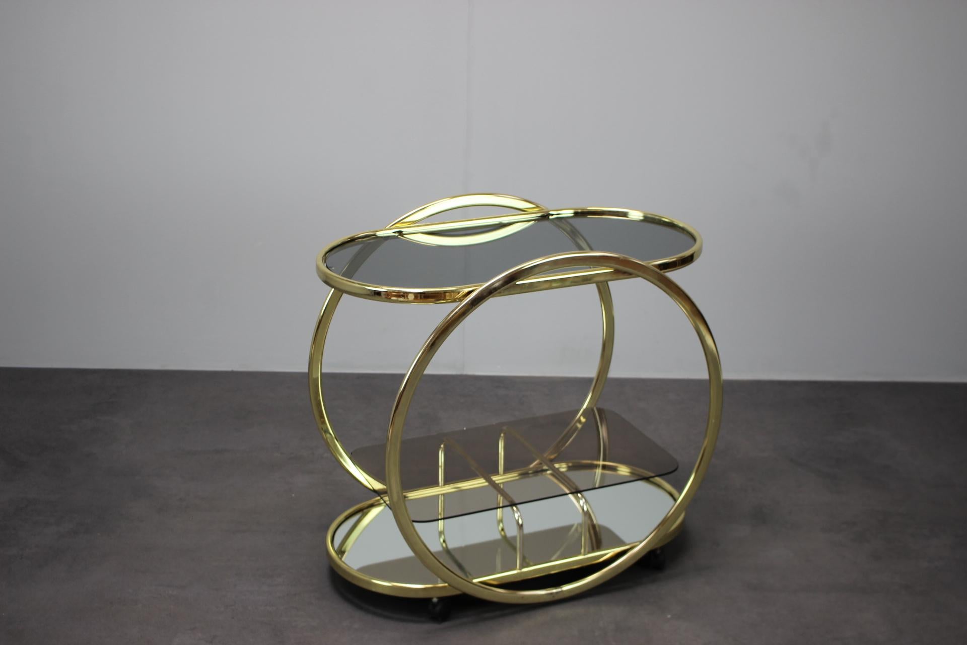 - Mid-Century Coctail Serving Bar Table made of Brass, 1970s, Germany,
- made of Brass and Smoked Glass and Mirror Glass,
- shows signs of wear and age (scratches, etc.),
- in good original condition.