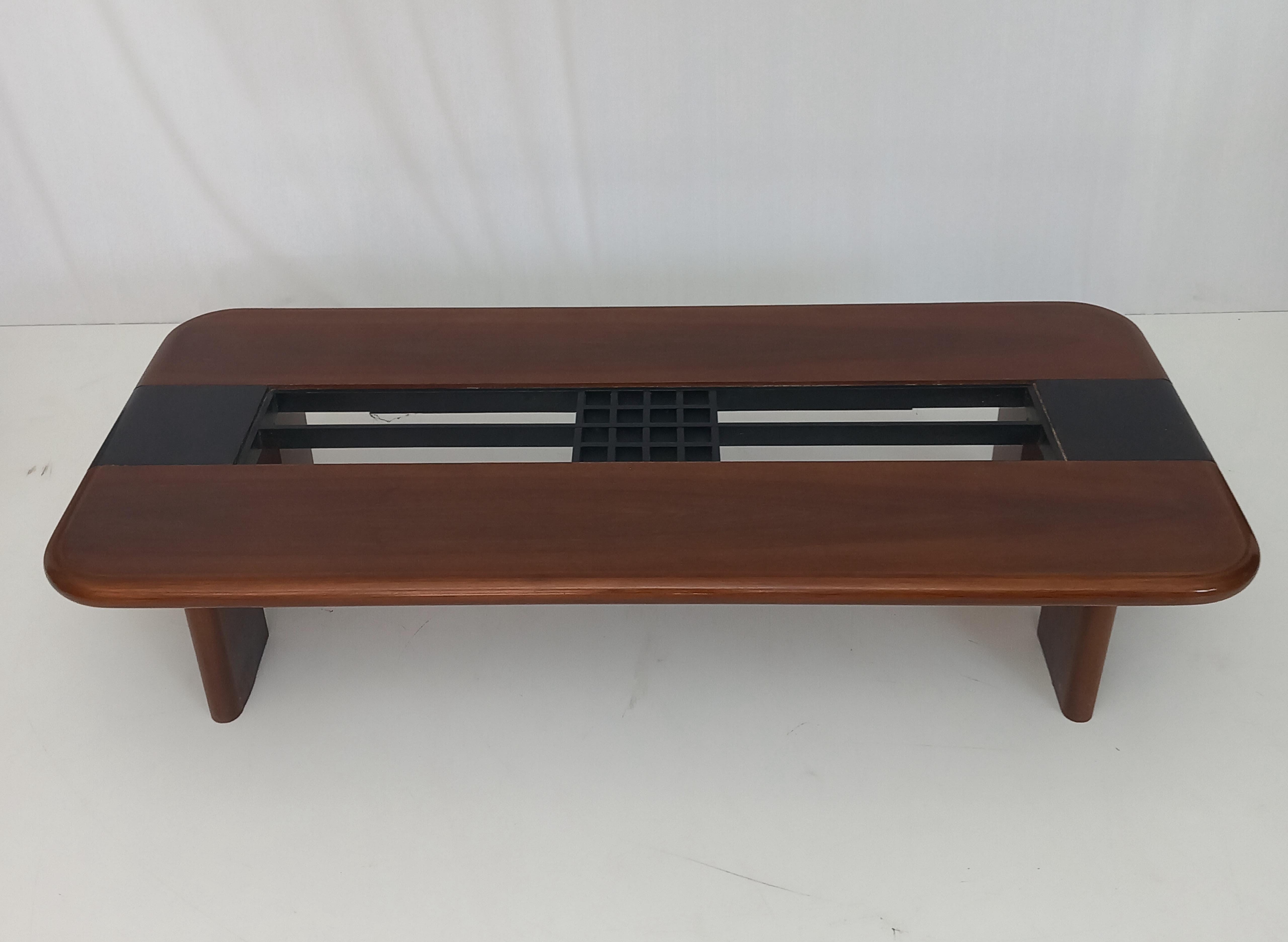 Elevate your living space with this elegant vintage coffee table, designed and produced in the 1980s, featuring a refined mid-century modern style with a distinctly peculiar design. Crafted with attention to form and function, this piece showcases a
