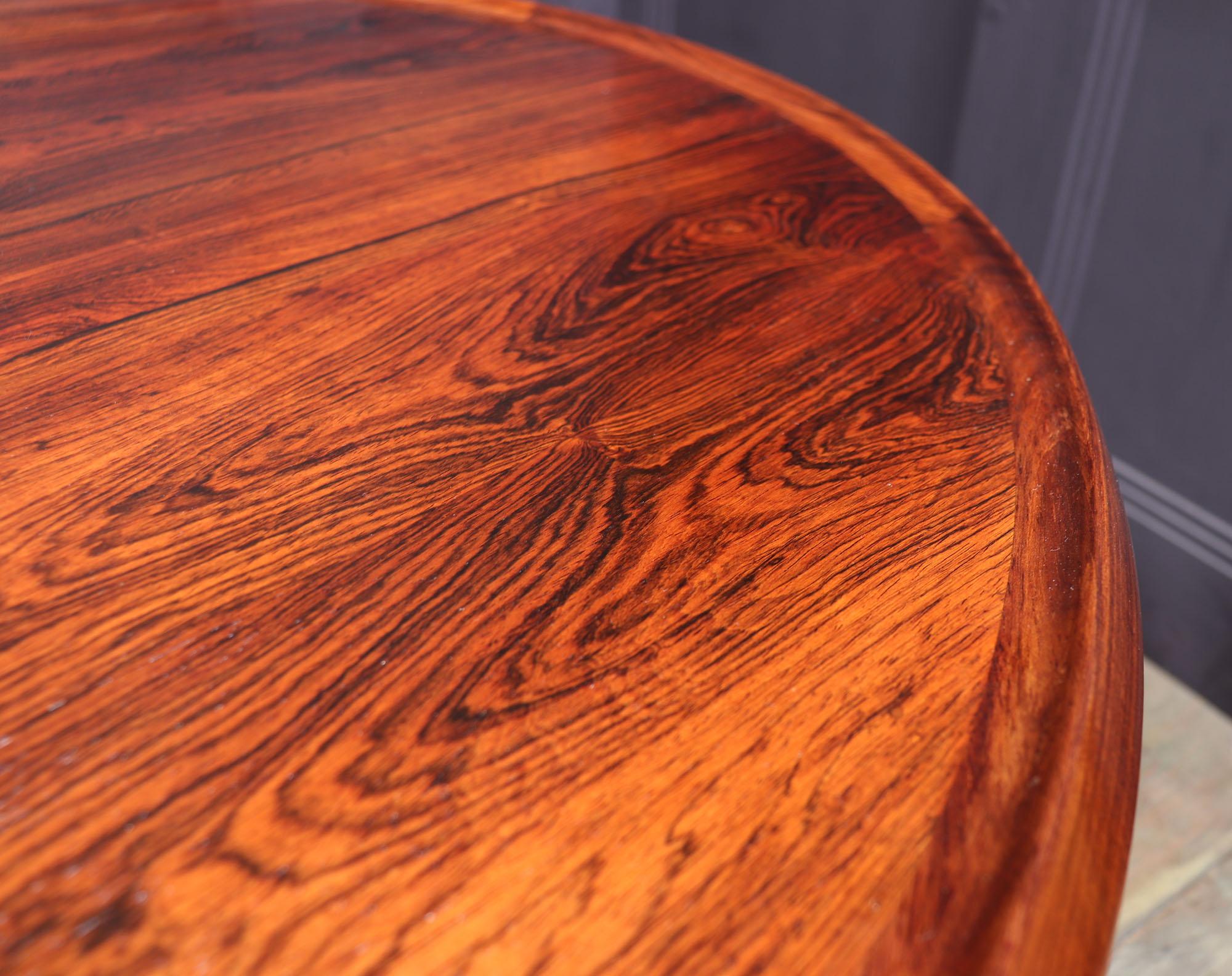 This stylish Mid-Century Modern coffee table features the design of Haug Snekkeri for Bruksbo. Produced in Norway by highly skilled craftsmen it features a rich rosewood finish, sturdy vintage construction, and a unique raised top edge. The table
