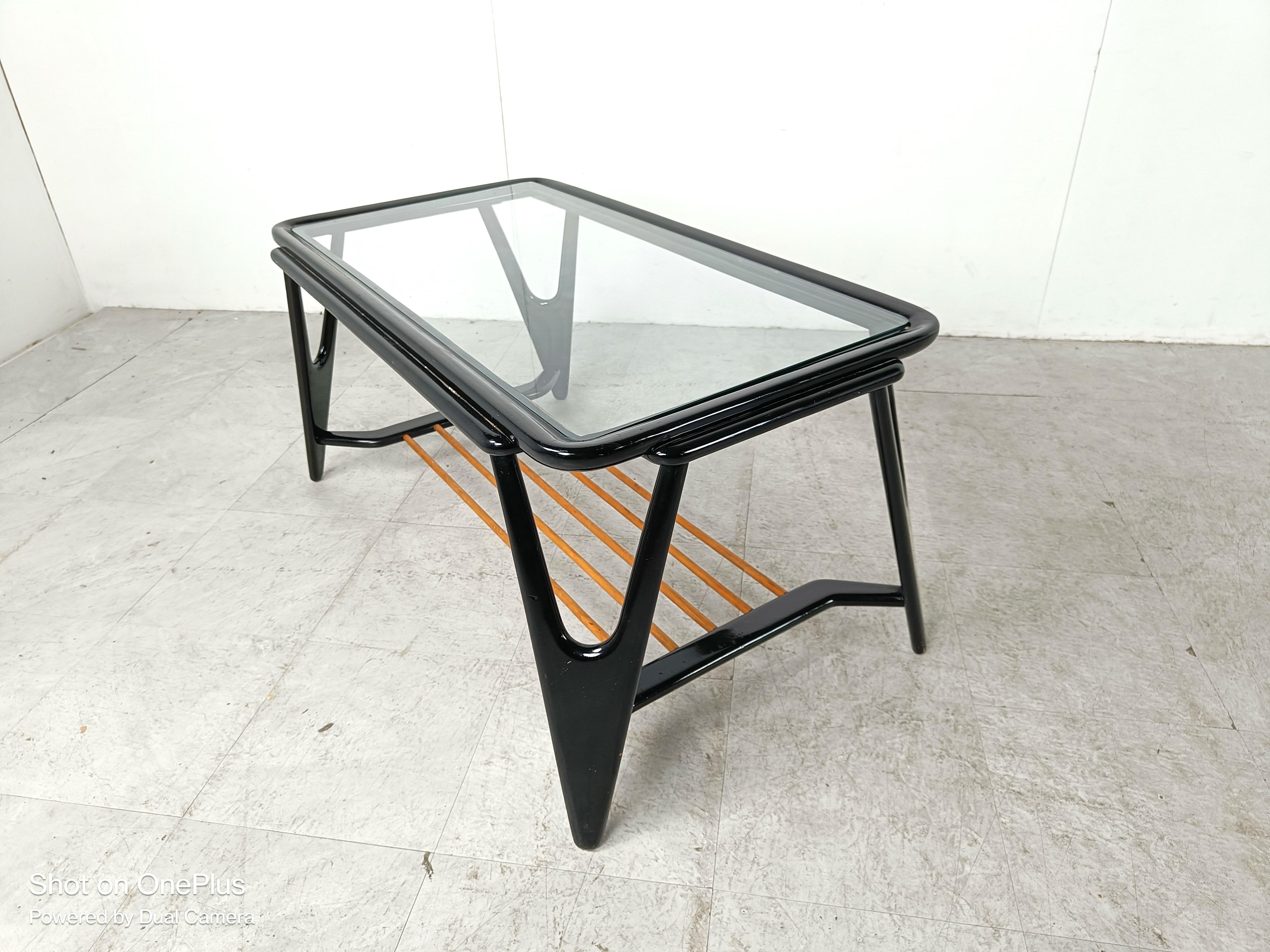 Elegant mid century coffee table by De Ster Gelderland.

The coffee table has a beautifully crafted lacquered wooden base, with a glass top and a clear wooden tube lower shel.

In the manner of Cesare Lacca, Alfred Hendrickx,..

1950s - The
