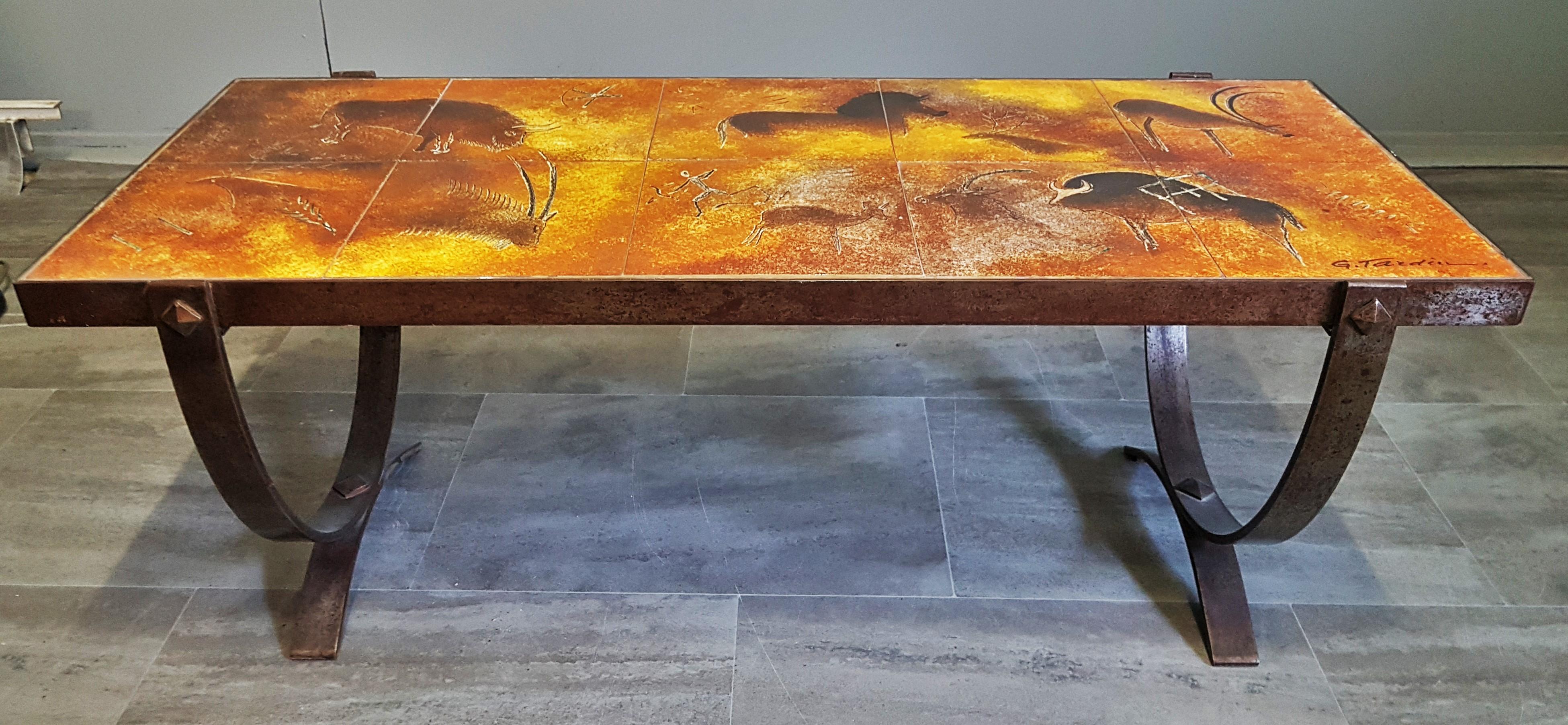 Midcentury coffee table by Georges Tardieu, Vallauris, France, 1960s.

Tiles with stone age decoration. Solid cast iron base.

Strong colors.