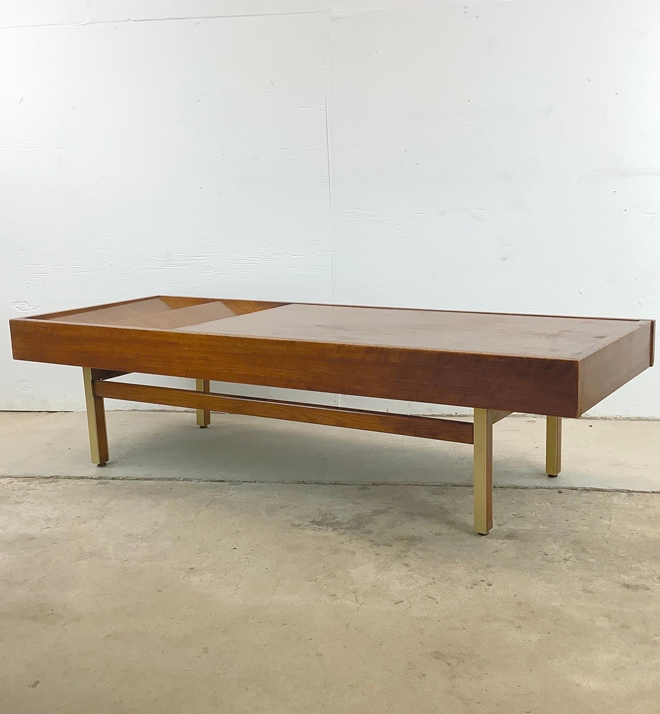Immerse yourself in the timeless allure of 1970s design with this exquisite Mahogany and Brass Coffee Table by Merton Gershun for American of Martinsville. Discover a perfect harmony between the warmth of mahogany and the elegance of the vintage