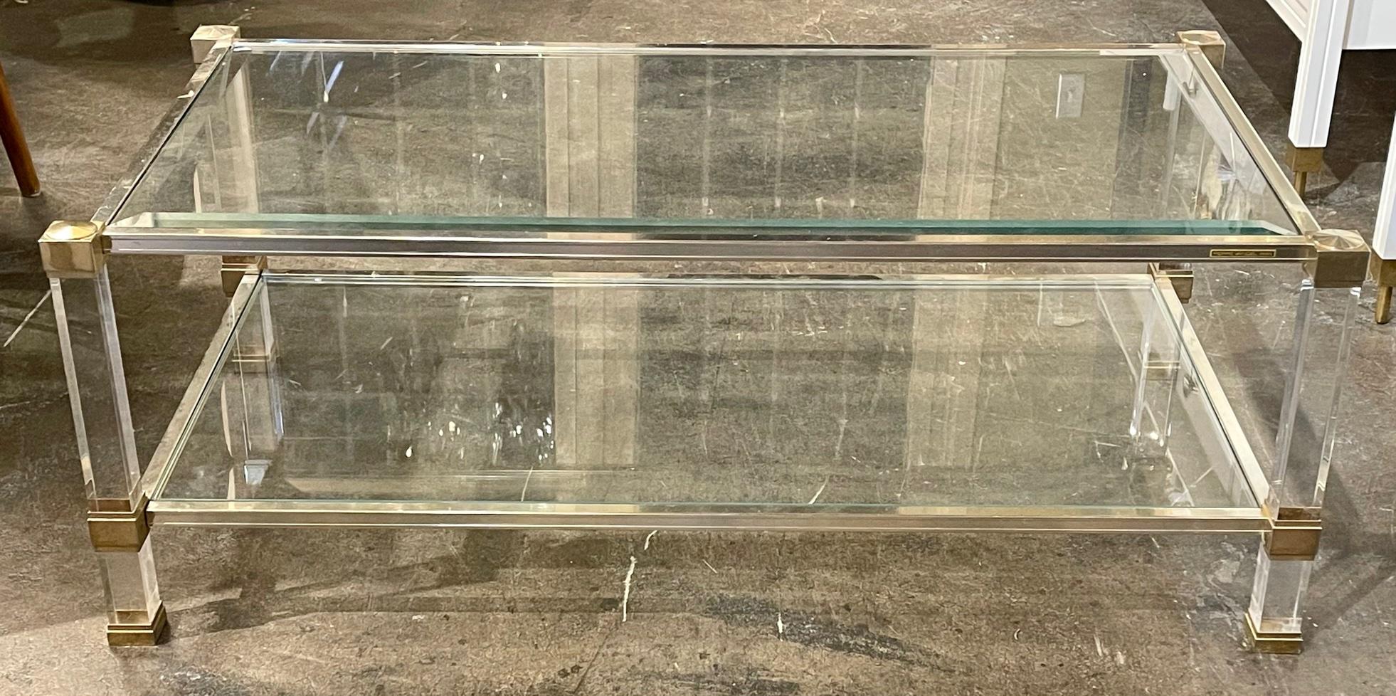 Mid-century French glass, lucite, and brass coffee table by Pierre Vandel Paris. Circa 1960. Perfect for todays eclectic design.