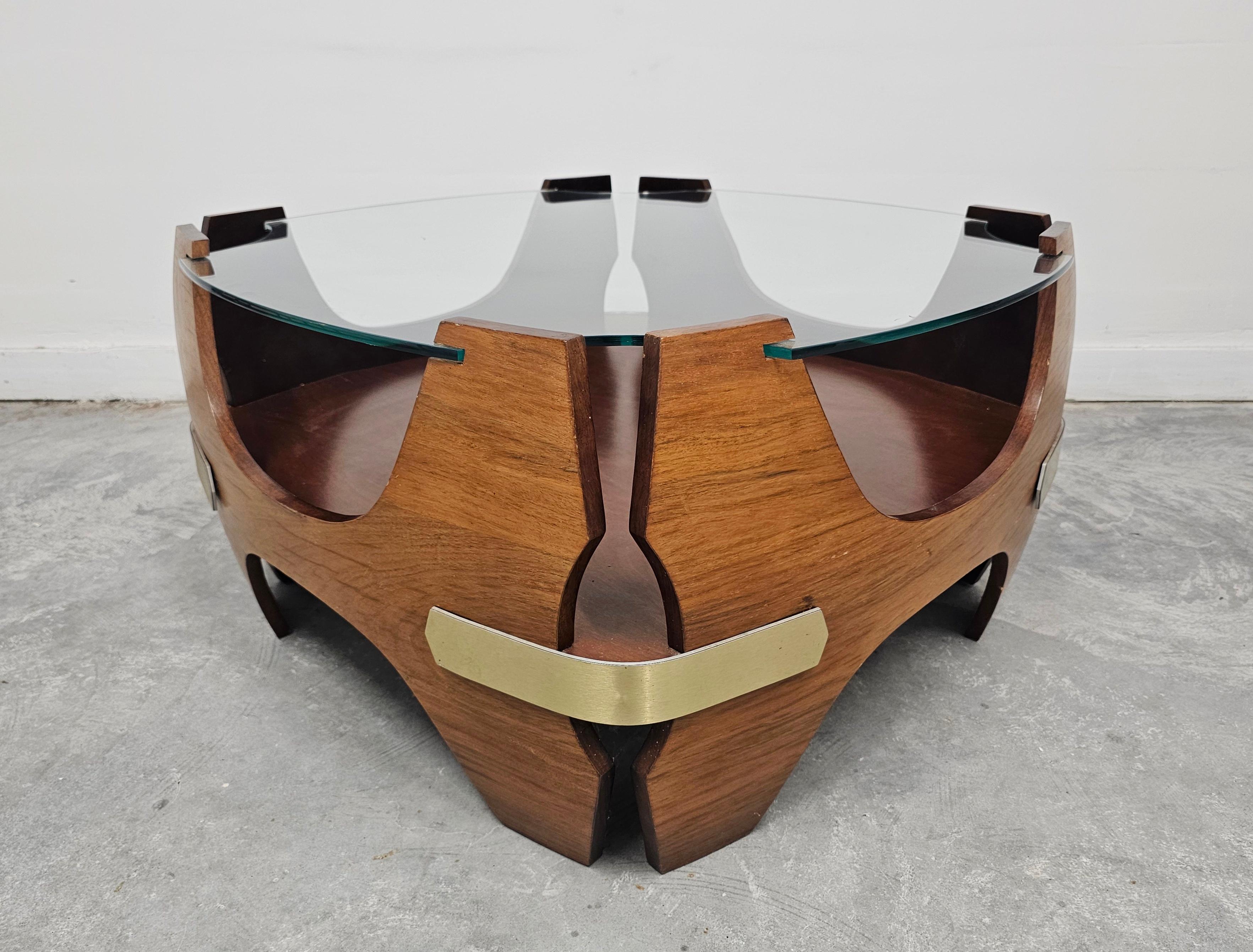 In this listing you will find a striking Mid Century Modern Molded Plywood Cocktail Table featuring the magazine rack and a uniquely shaped glass top. The piece is reminiscent of designs by Charles and Ray Eames. Made in Italy in 1940s.

Good
