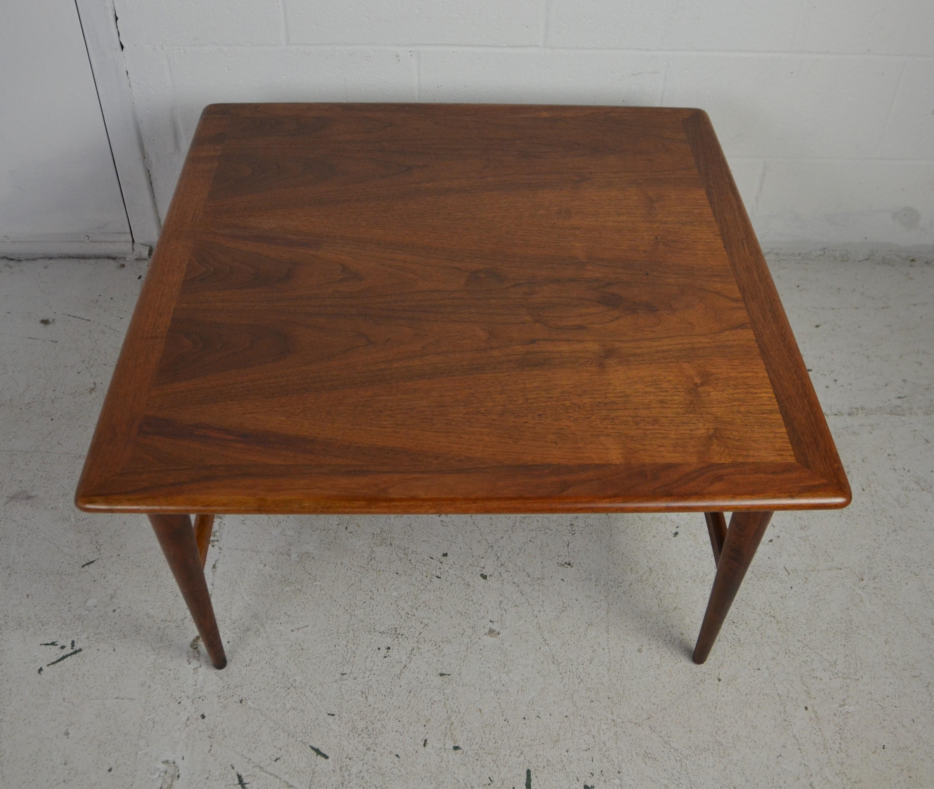 Midcentury coffee table with stretcher base.