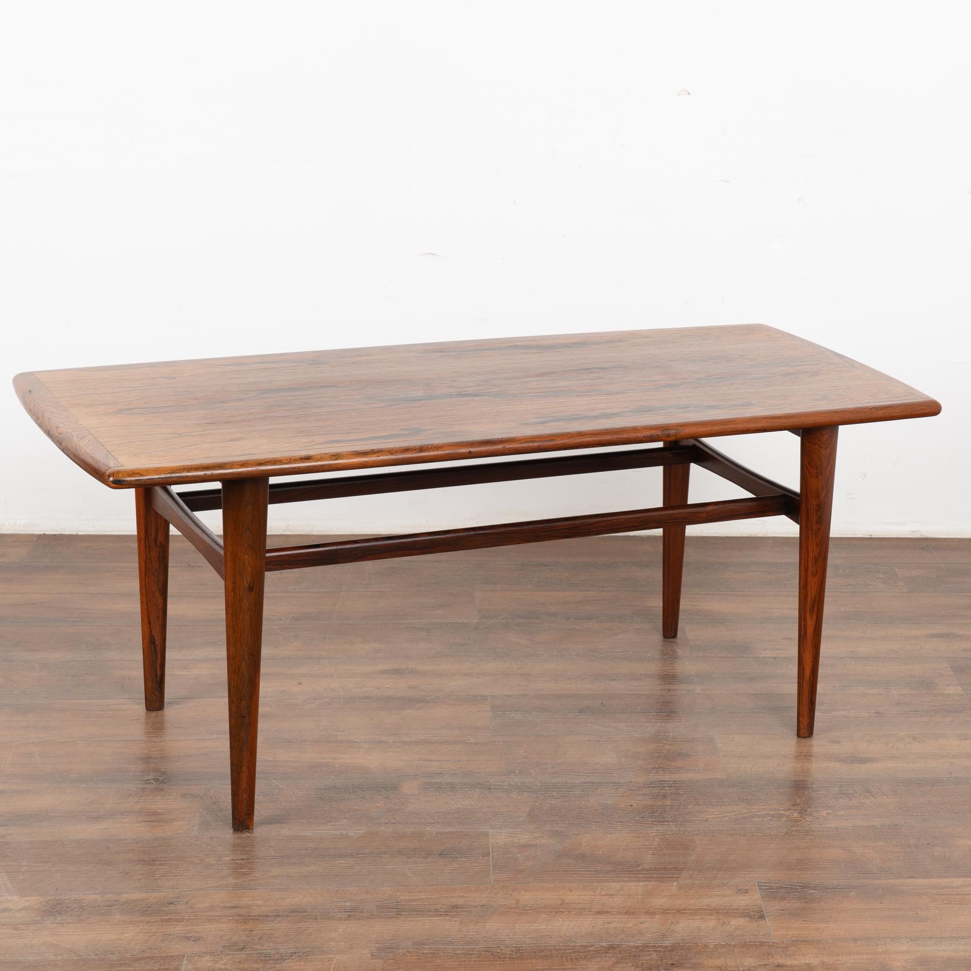 Classic clean lines are the highlight of this mid century modern coffee table from Denmark, along with the striking wood grain that creates the attractive top.
Any small nicks, scratches, signs of wear are commensurate with age and do not detract