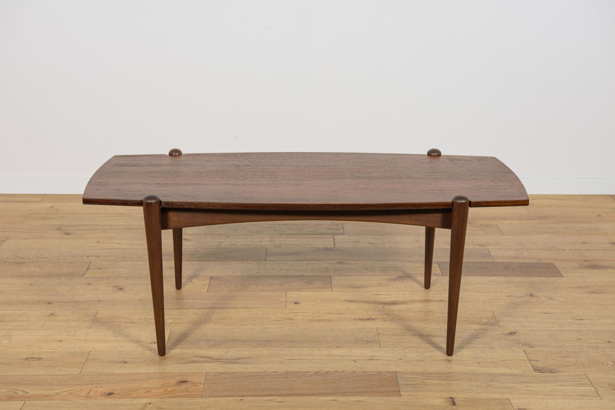 Coffee table produced in the 60s in the Swedish Dux factory. Teak table with a light, sophisticated form and high carpentry craftsmanship. The table has an interesting connection of legs with the top. The furniture has undergone professional