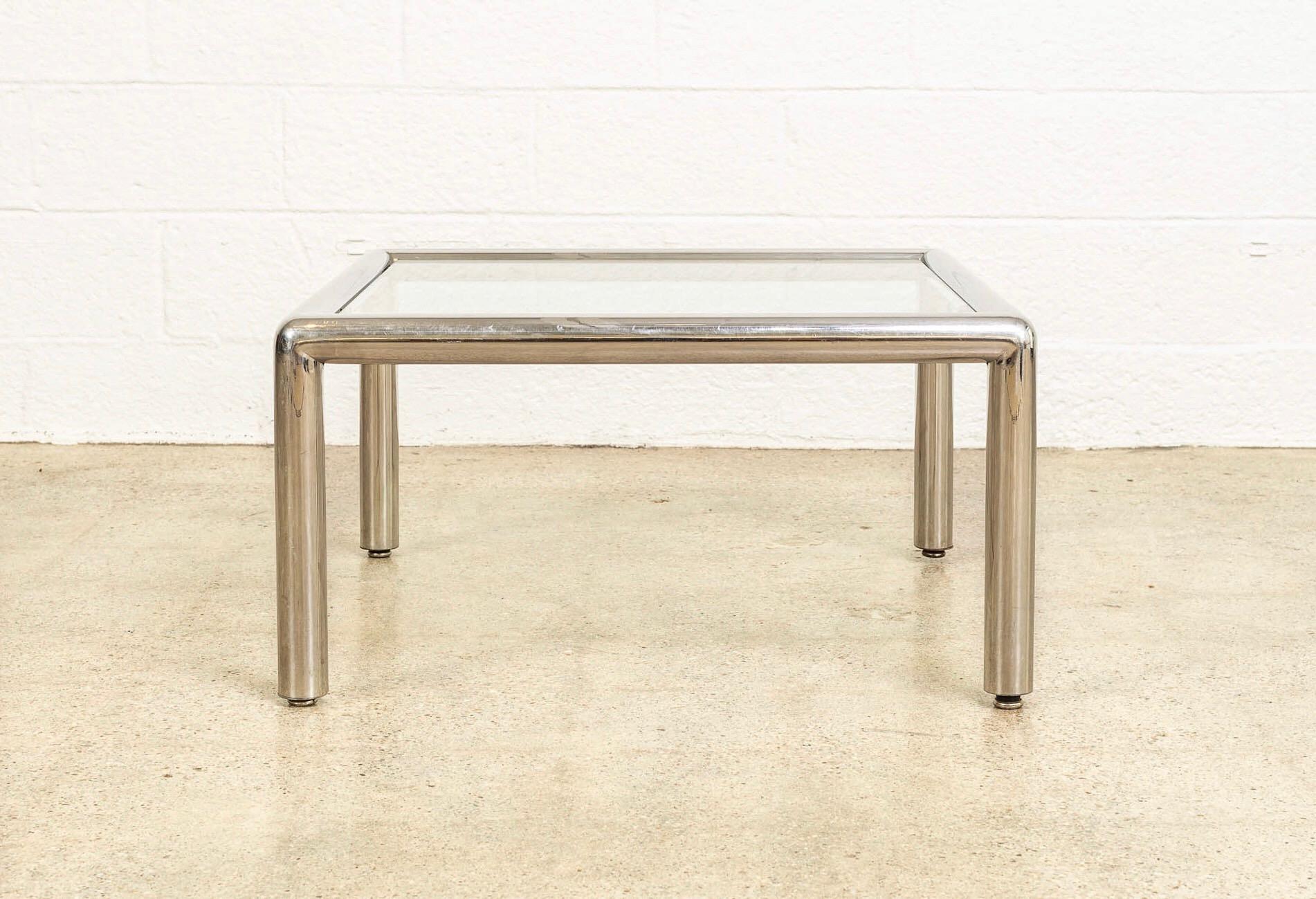 This vintage Mid-Century Modern “Tubo” chrome and glass coffee table was designed by John Mascheroni in 1967. It features a welded polished aluminum tubular frame with a chromed appearance. This table has a brand new 3/8” thick piece of replacement