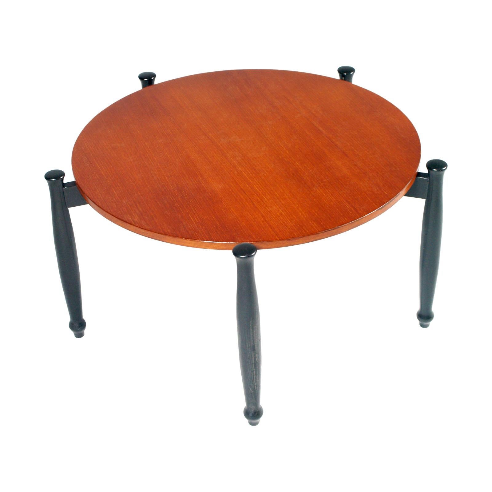 Midcentury Ilmari Tapiovaara attributed round six legs coffee table in ebonized walnut structure and with the top veneered in teakwood. Wax polished

Measures cm: Height 41, diameter 78.

About:
In 1937 he graduated in interior design and in