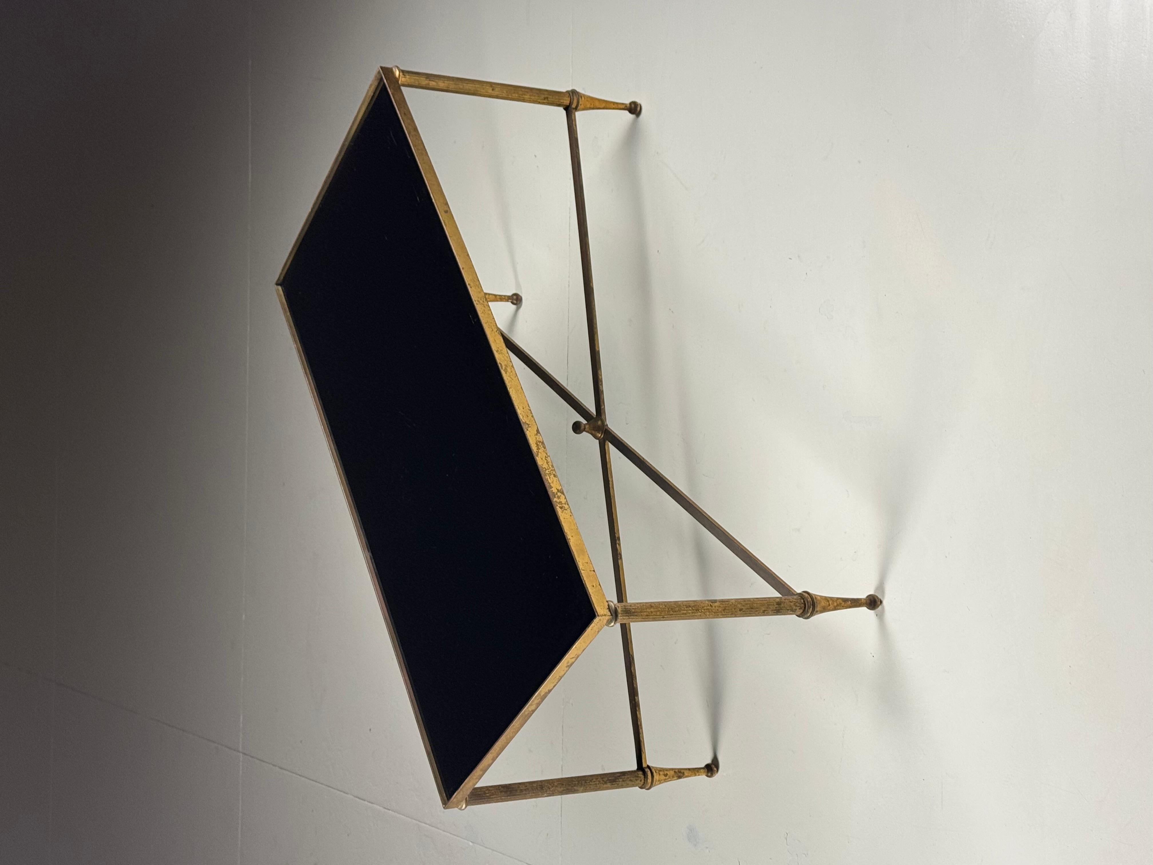 Mid-century coffee table with black glass top

Mid-century coffee table/side table.
Brass, with black glass top.

Dimensions: 85L x 43D x 41H cm