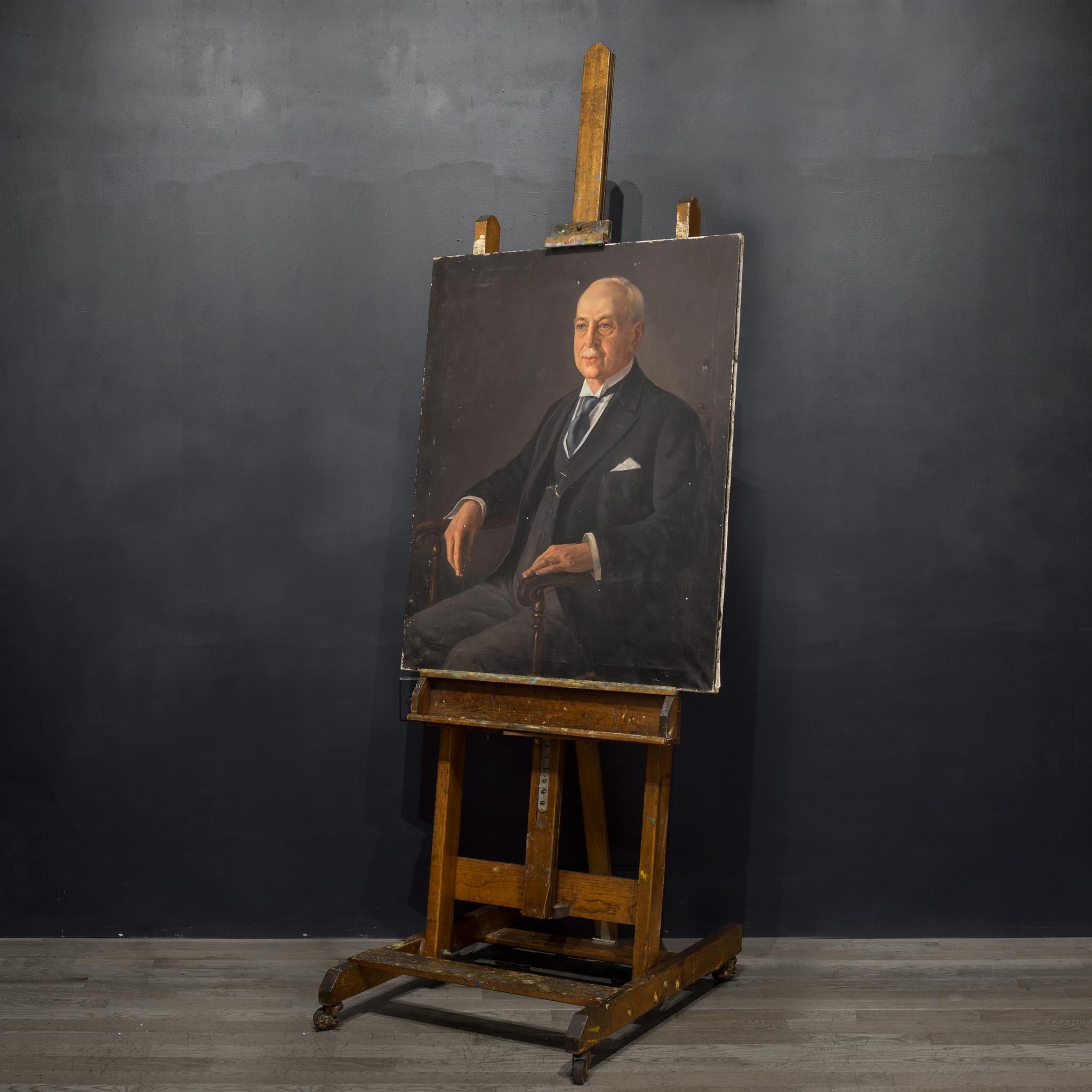 This is an original midcentury large wooden easel on casters with brush and paint storage shelf in the front. The easel has an adjustable angle and frame size to accommodate any size picture frame. The easel is collapsible and folds flat. This piece