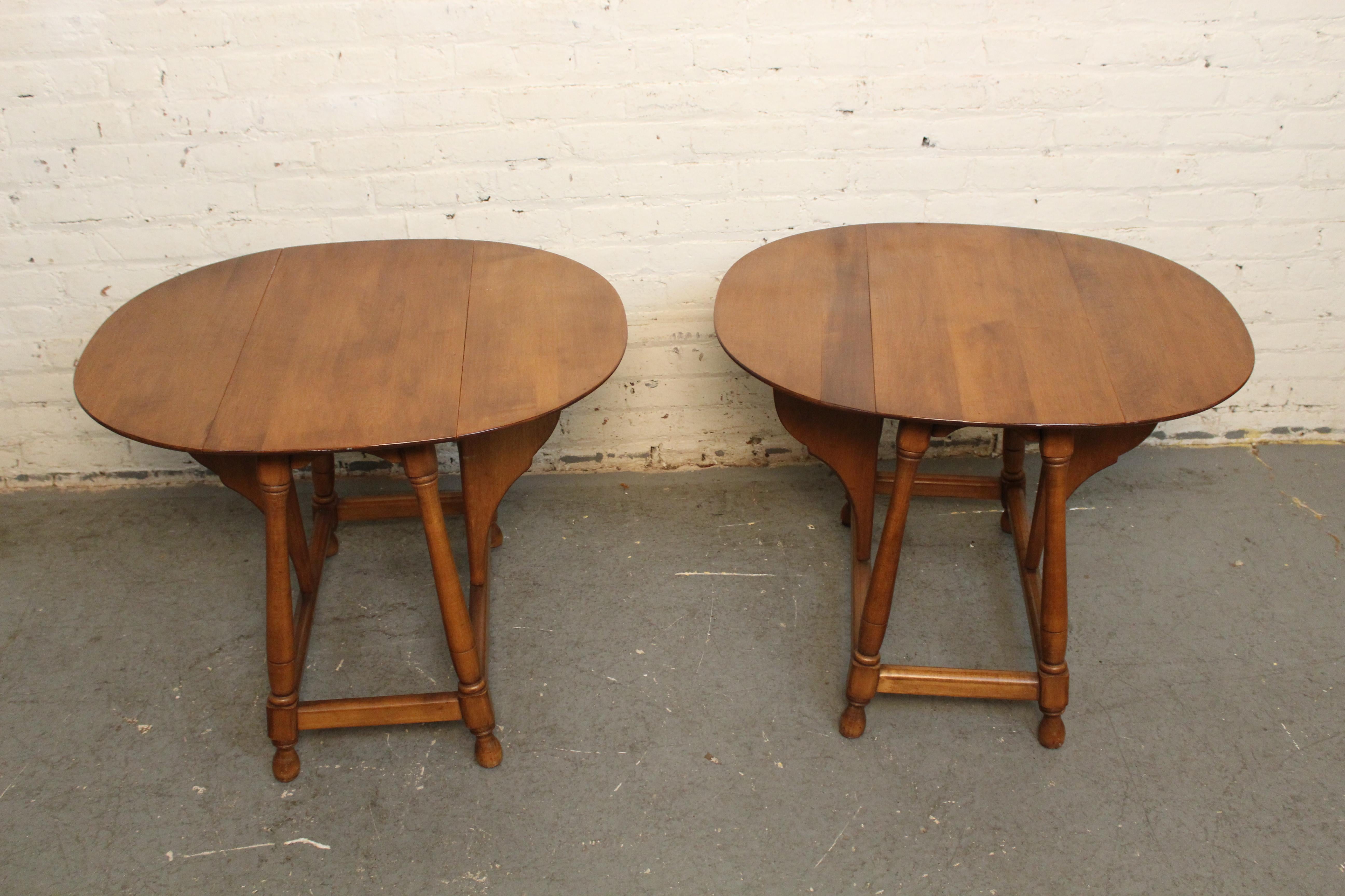 Revitalize the spirit of '76 with these charmingly chic Colonial drop leaf side tables! Constructed of solid American maple with turned legs and carved butterfly hinges, each table opens from a compact 14x26