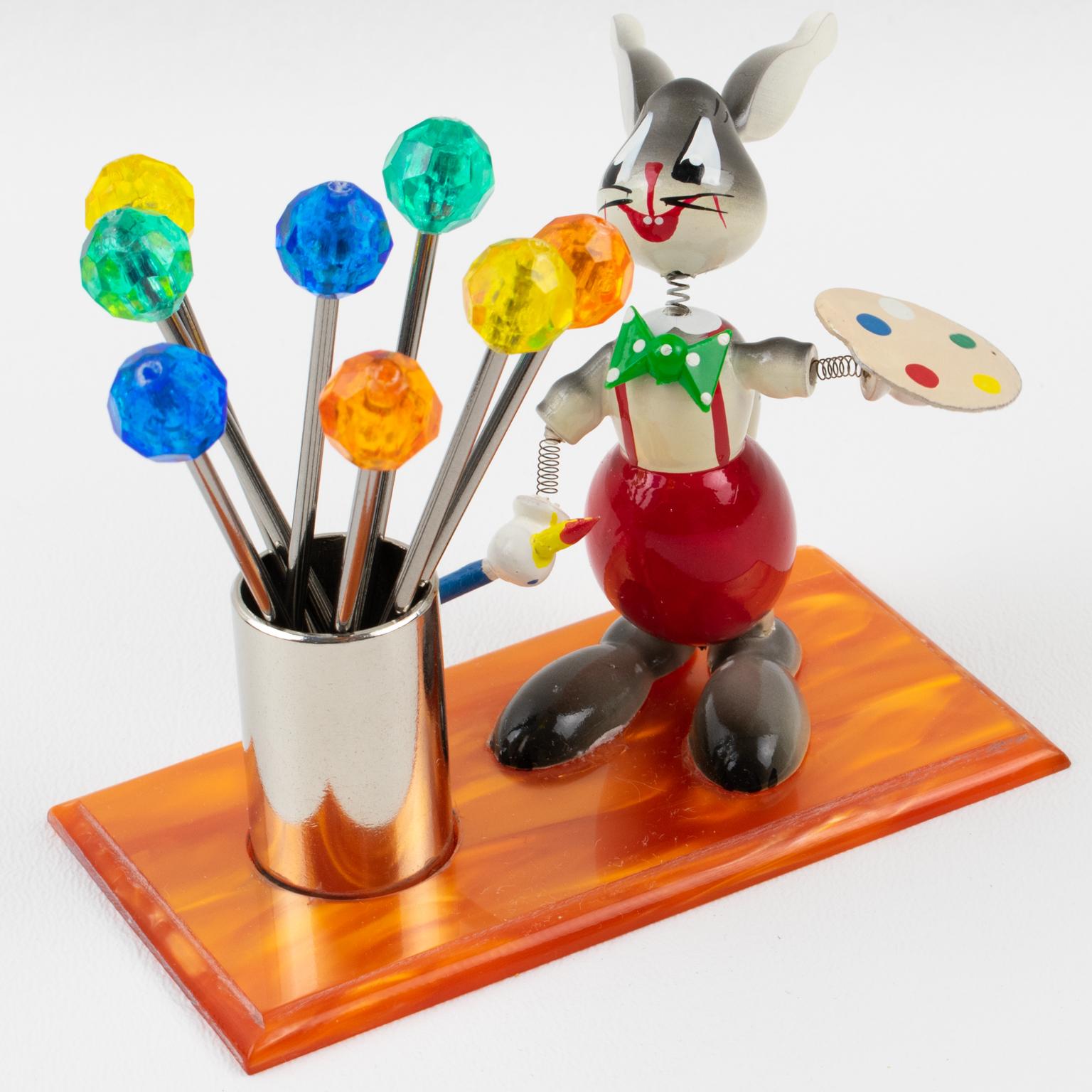This adorable French Mid-Century bar cocktail pick accessory was crafted in France in the 1960s. This little guy is probably not Picasso, but he will be a great conversational piece for your next party with friends !!
The bar set includes a wooden