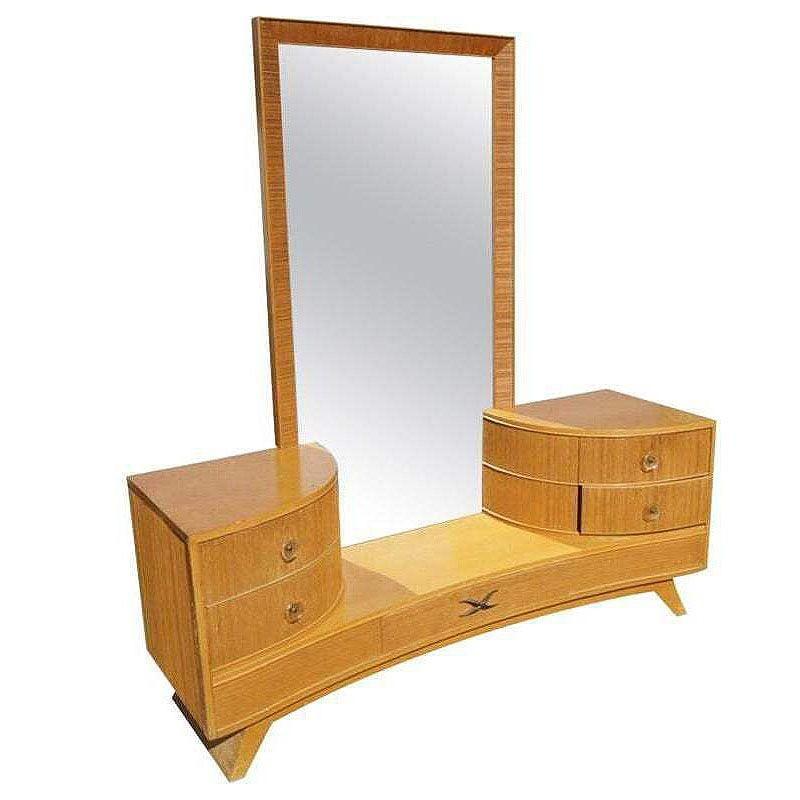 Early Mid-century vanity with matching stool by Paul Frankl for Brown Saltman company features his trademark combed wood sides with curled brass pulls. The Vanity includes two convex curved drawers per side with acrylic pulls and tall combed wood