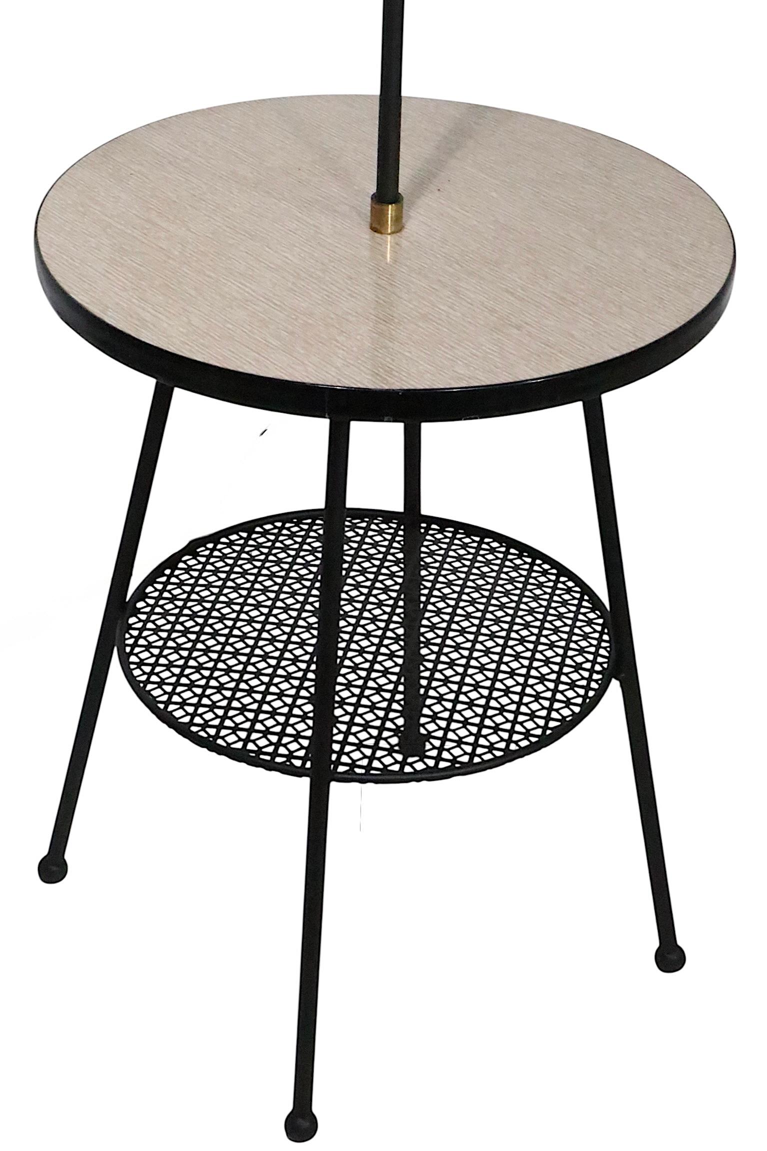 Classic Mid Century combination flor lamp, side table, having two shelves, with a pole lamp center. The lamp is in very good, clean and ready to use condition, we have newly respray painted the black metal elements, shade is not included. 
 Total H