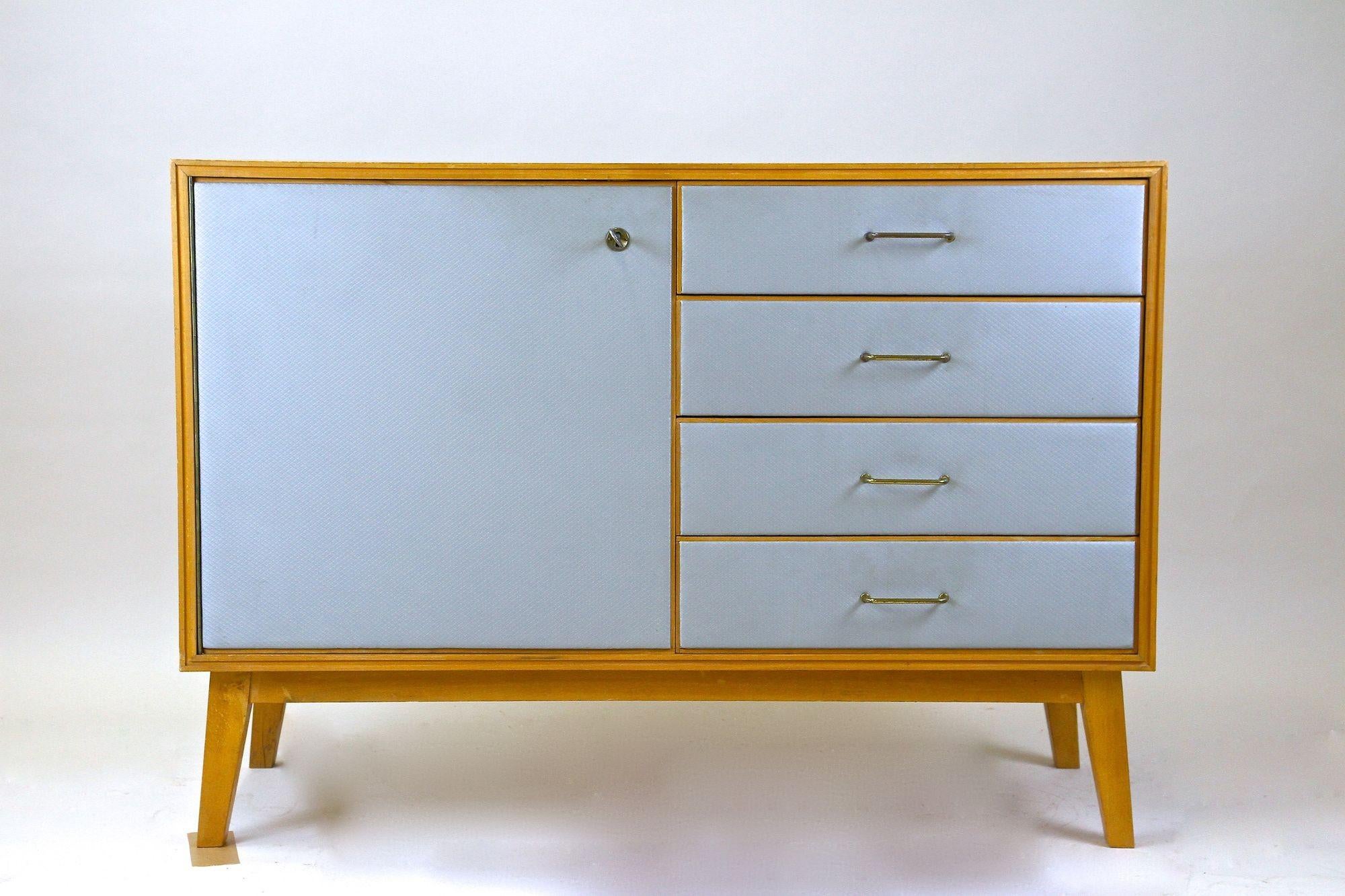 Extraordinary mid-century commode or chest of drawers with powder blue fronts made by SW Furniture in Vienna/ Austria around 1960. A perfect sized commode unusually crafted out of oriented strand boards which confers this uncommon piece of
