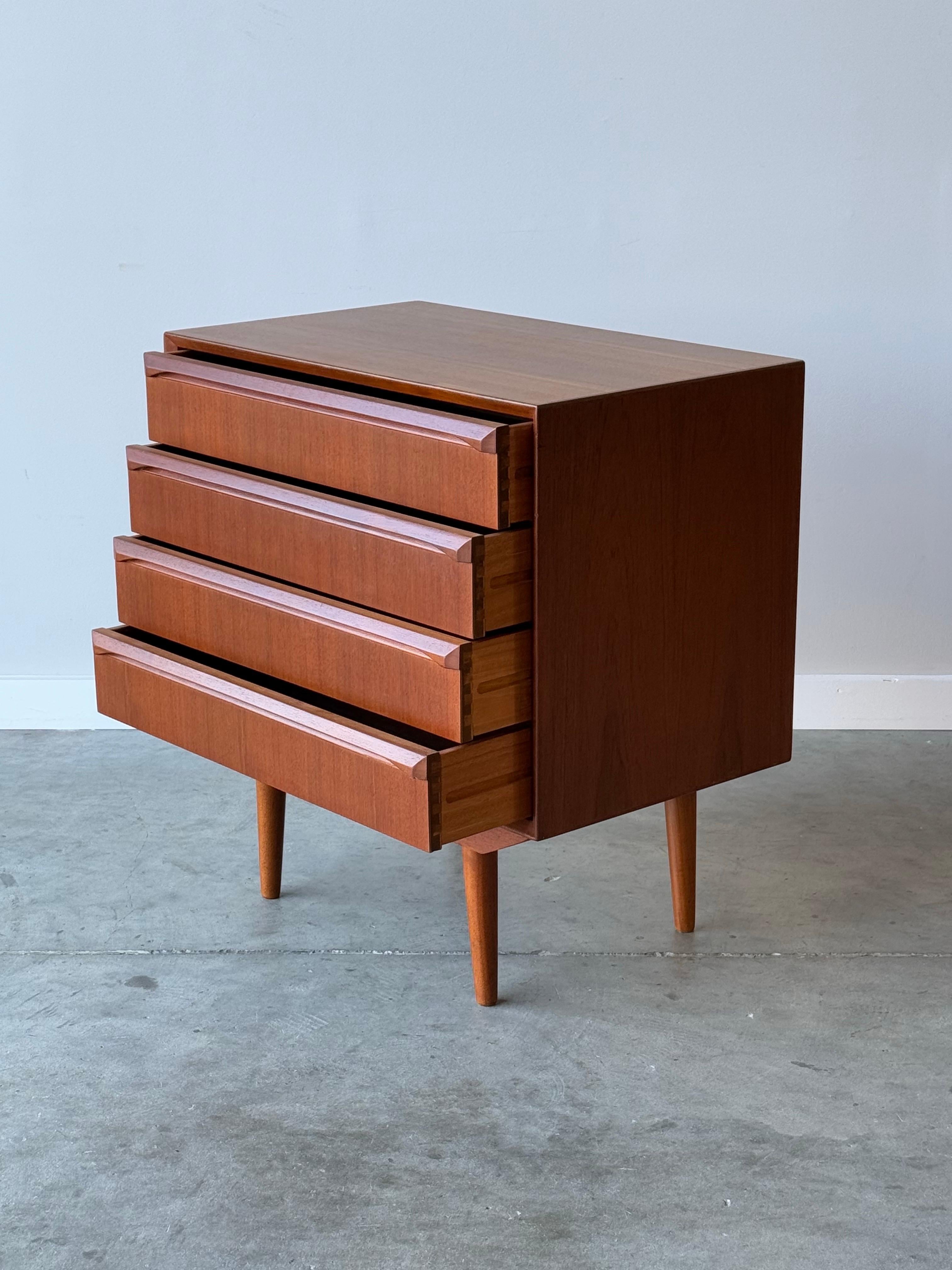 Mid-century compact four drawer dresser. Made in Denmark from teak wood. The perfect piece for those who may need a little extra storage or in a kids room. This case piece is wonderfully made and equipped with four smooth sliding drawers. Drawers
