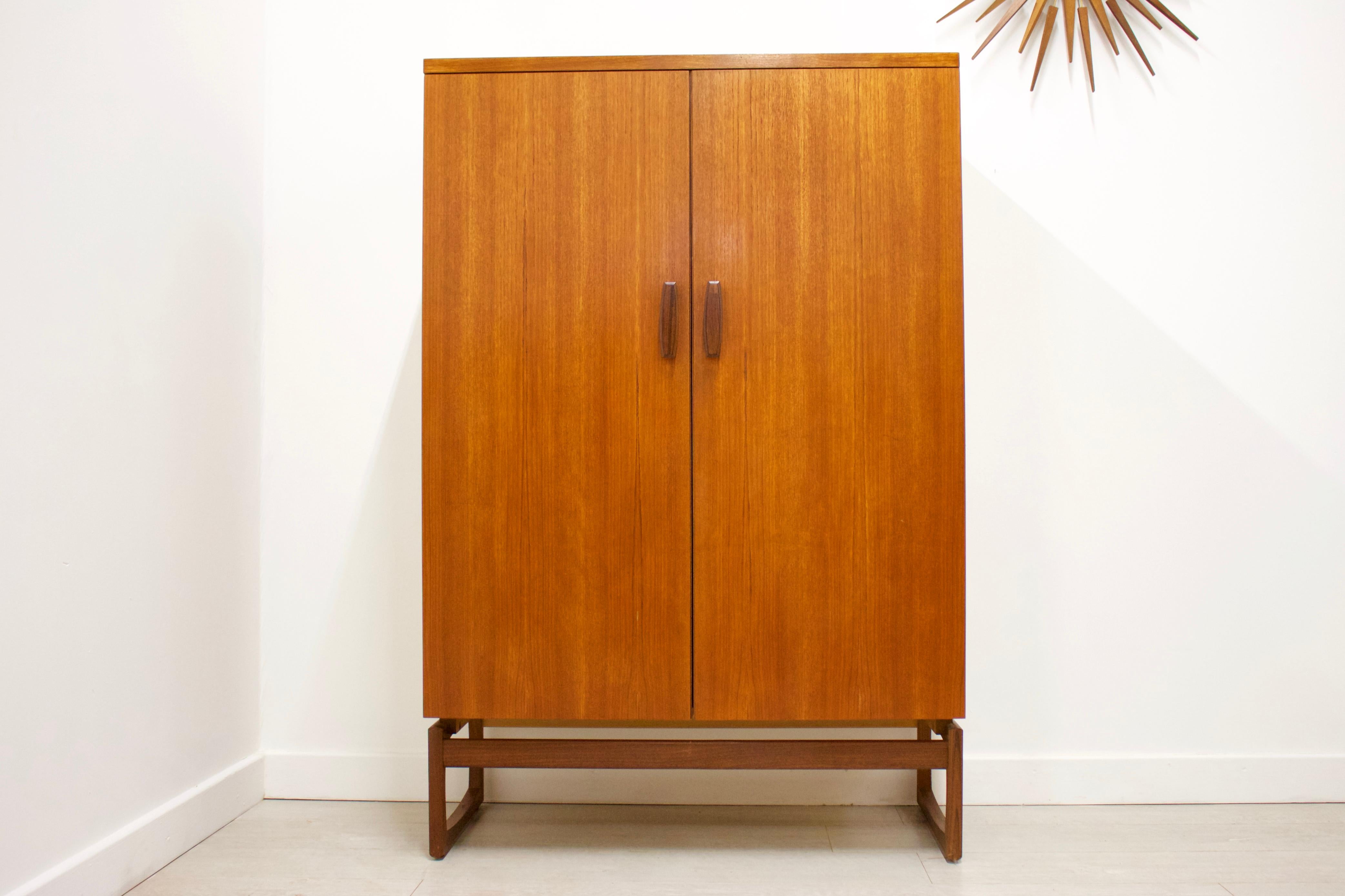 - Mid-Century Modern wardrobe
- Manufactured by G-Plan
- Made from Teak
- Features a pull-out hanging rail on the left, 2 drawers on the top right and 2 shelves on the bottom left for ample storage.