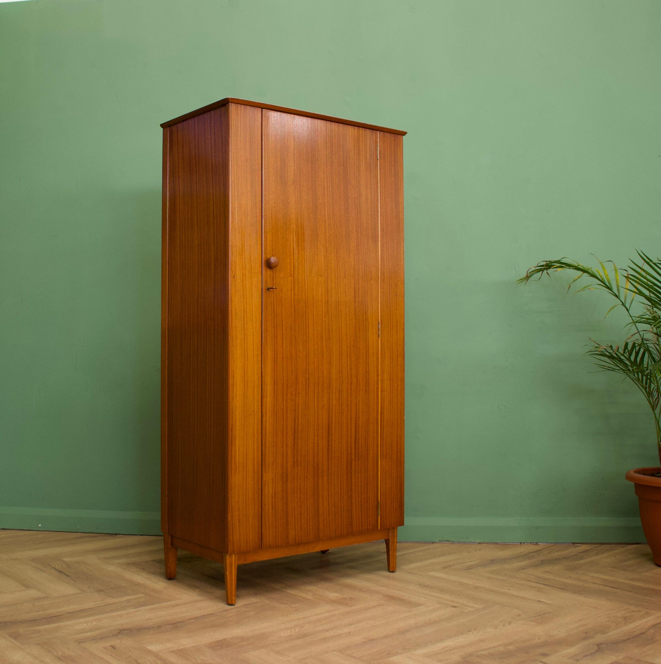 Mid century modern compact wardrobe 
Manufactured by Lebus in the UK. 
Features a hanging rail and shelves
    