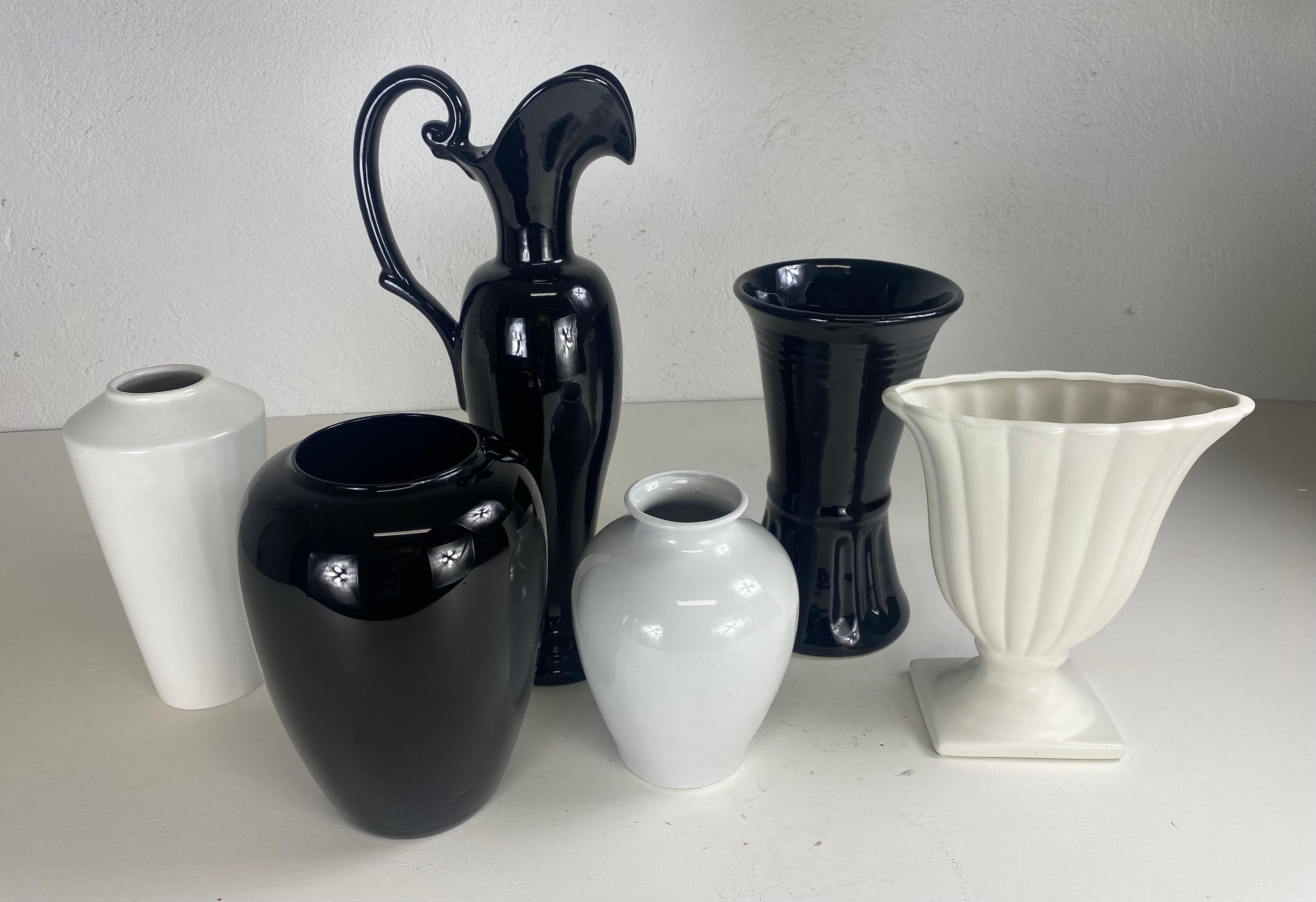Hand-Crafted Mid century complementary grouping of black and white pottery vases. For Sale