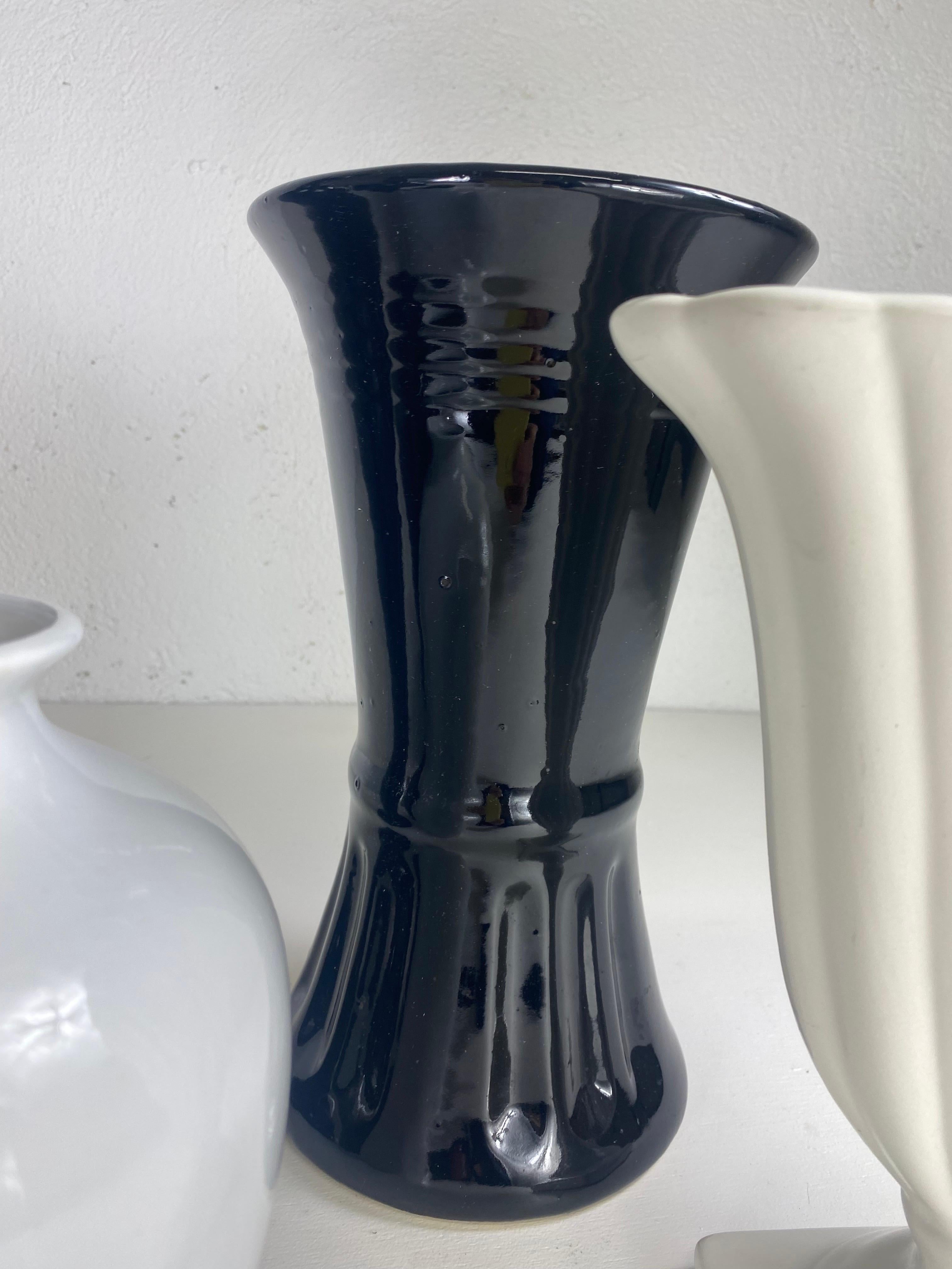 Pottery Mid century complementary grouping of black and white pottery vases. For Sale