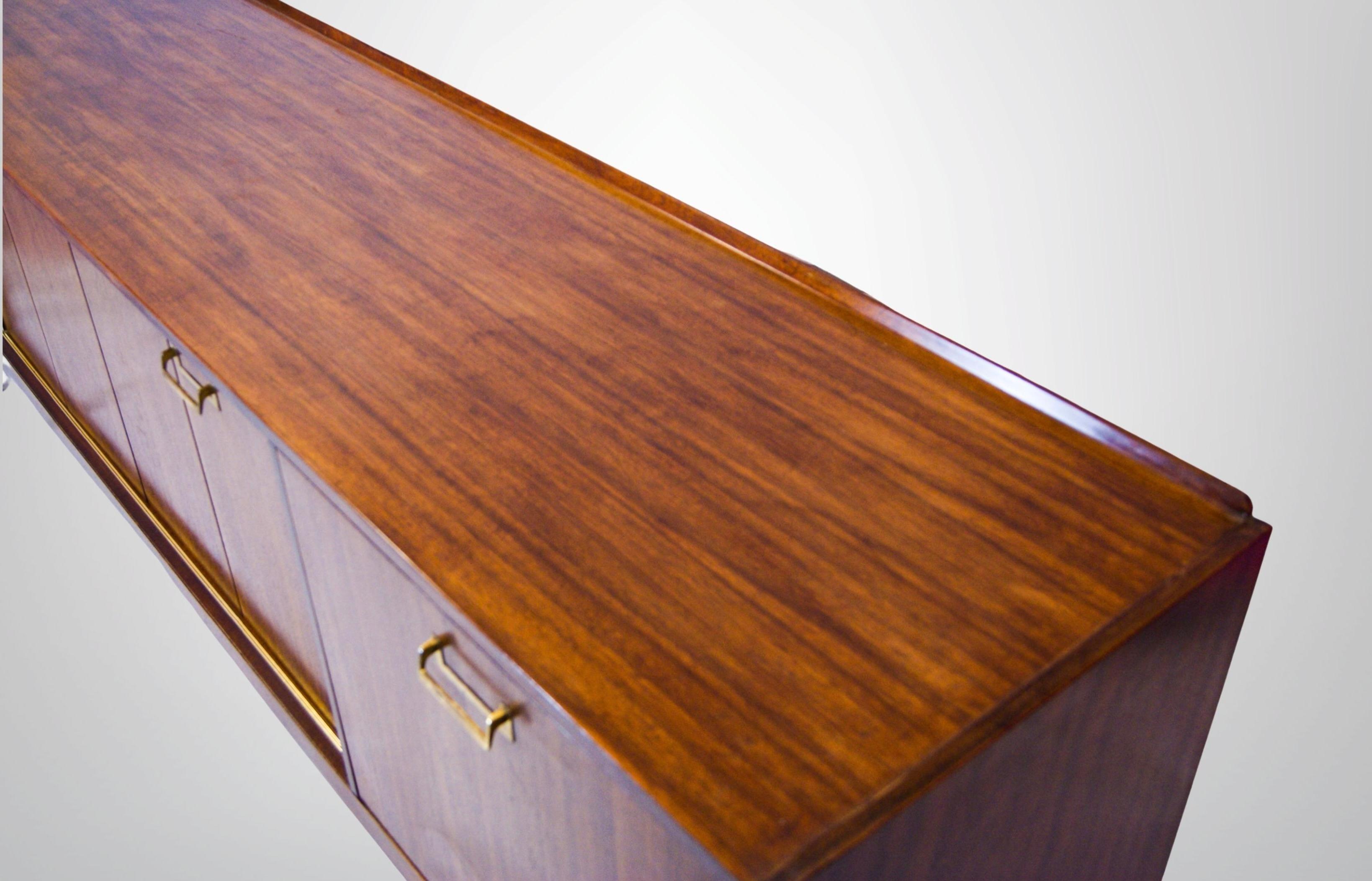 Retro 1950s Long Teak Sideboard by Ebenezer Gomme .
With nice concertina doors, unique E Gomme solid brass handles and brass ferrule feet. .
Over 7ft+ long solid teak top. 
Roomy double doored concertina style buffet cupboard with internal