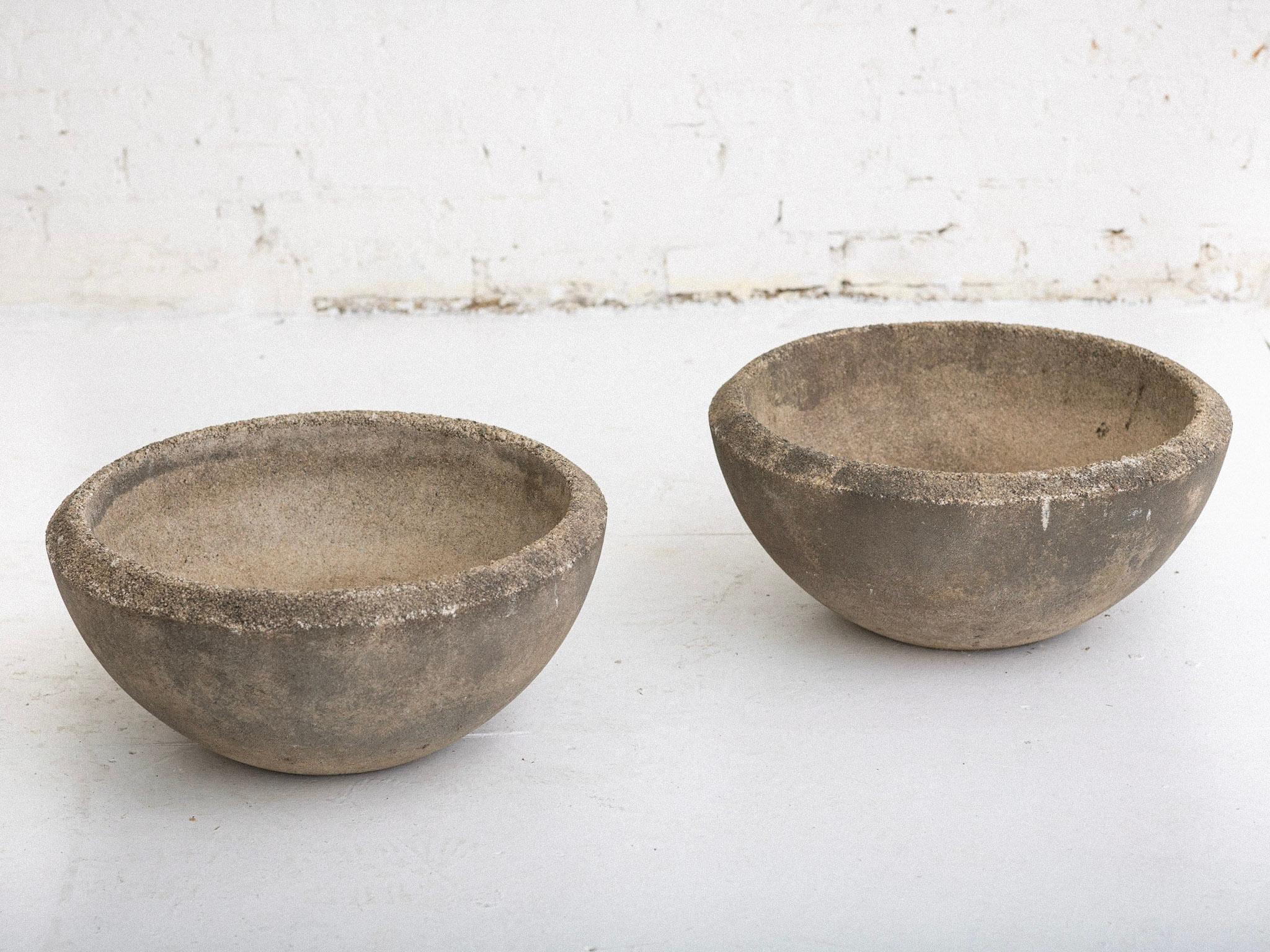 A pair of midcentury concrete cast stone planters. Half globe silhouettes. Drainage holes. Darkened weathered patina.
