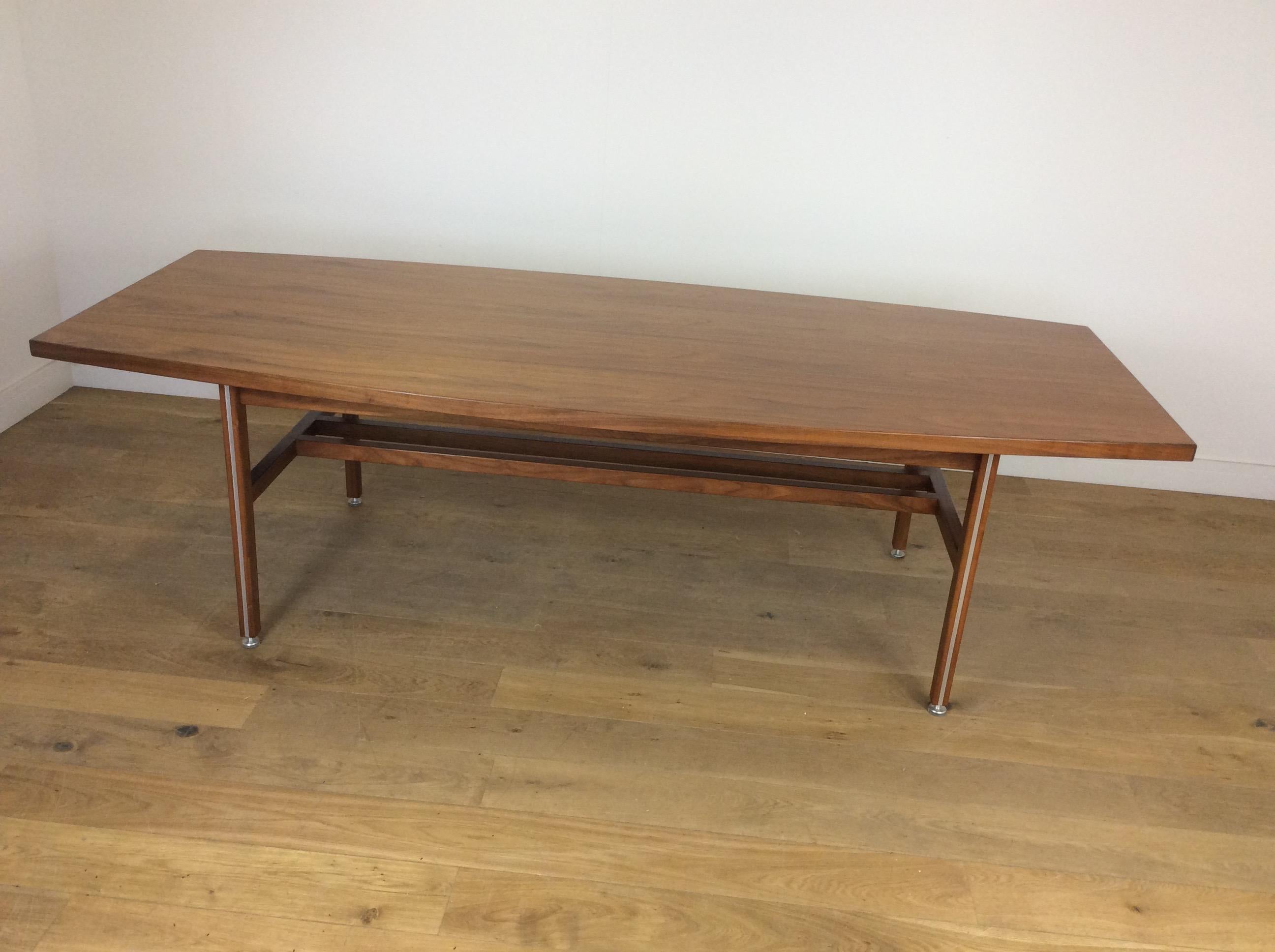 Midcentury 8ft long conference table in a beautiful walnut.
Raised on square column legs with inset aluminium with cross stretcher.
Height adjustable feet for perfect balance.
In the manner of Florence Knoll
Measures: 72.5 cm H, 244 cm W, 106 cm
