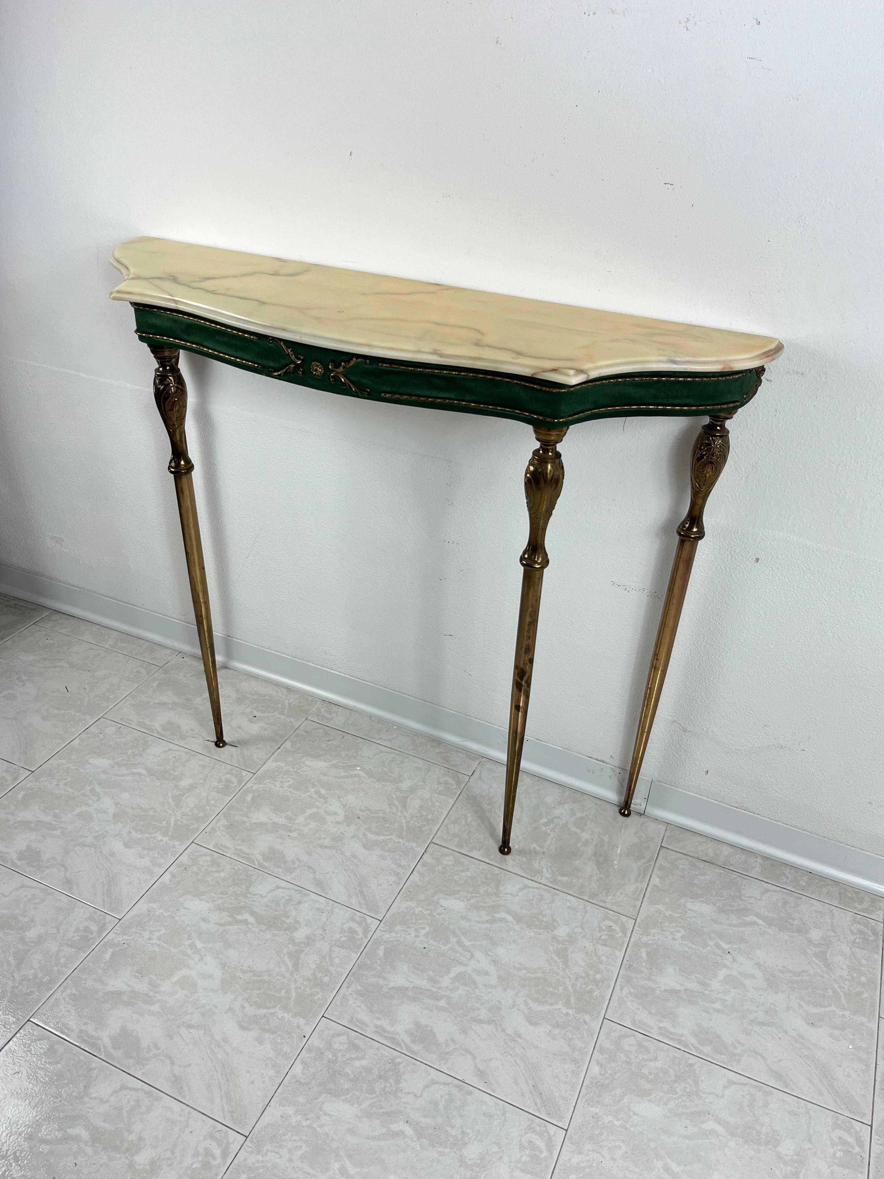 Mid-Century console and mirror attributed to Paolo Buffa 1960s
The wooden console covered in silk and brass details has a marble top and brass feet.
The mirror has an edge covered in green silk and a brass frieze in the center.
Good condition, small