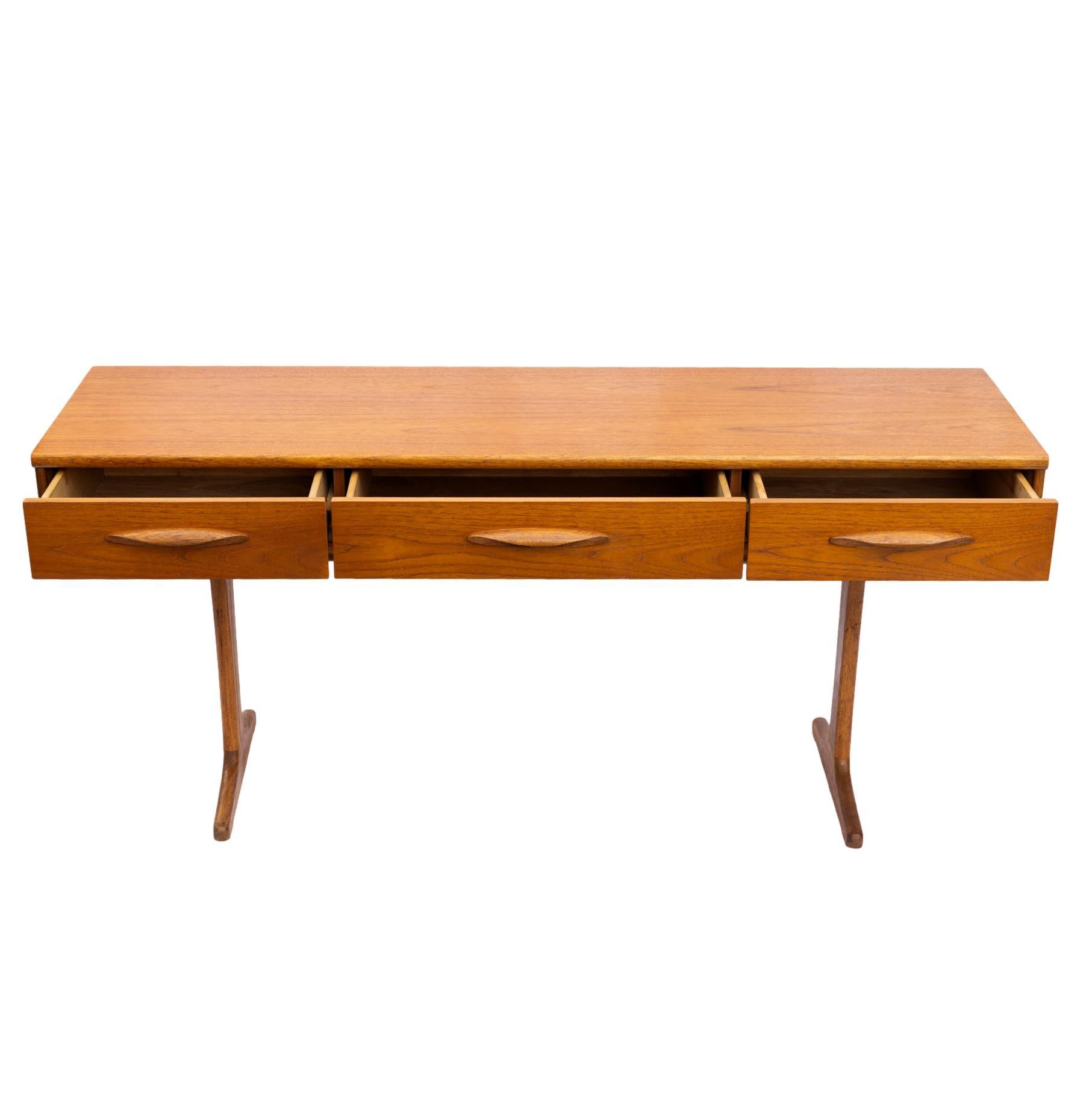Mid-Century Modern console/sofa table Designed by Frank Guille (1926--2018) for Austinsuite, of rectangular form with three drawers, each having molded pulls, on Danish Modern legs, the center drawer with the maker's stamp, 'austinsuite, REGD