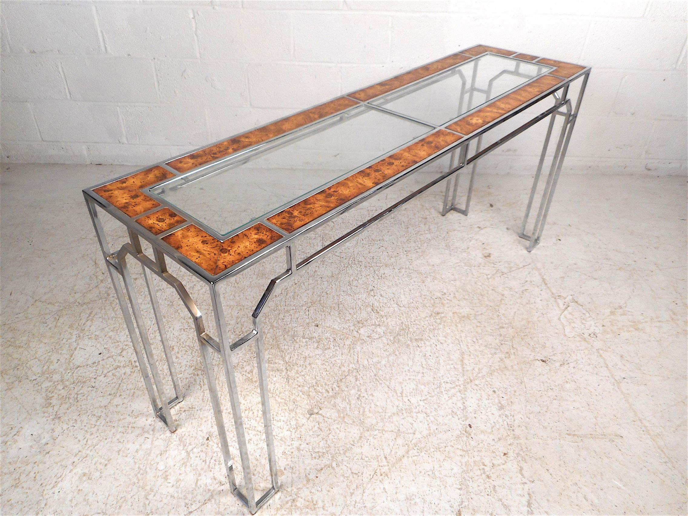Stylish console table by Milo Baughman. Sleek angular chrome frame with burl inlays and two glasses inserts which serve as a tabletop. Great addition to any modern interior, circa 1960s. Please confirm item location with dealer (NJ or NY).